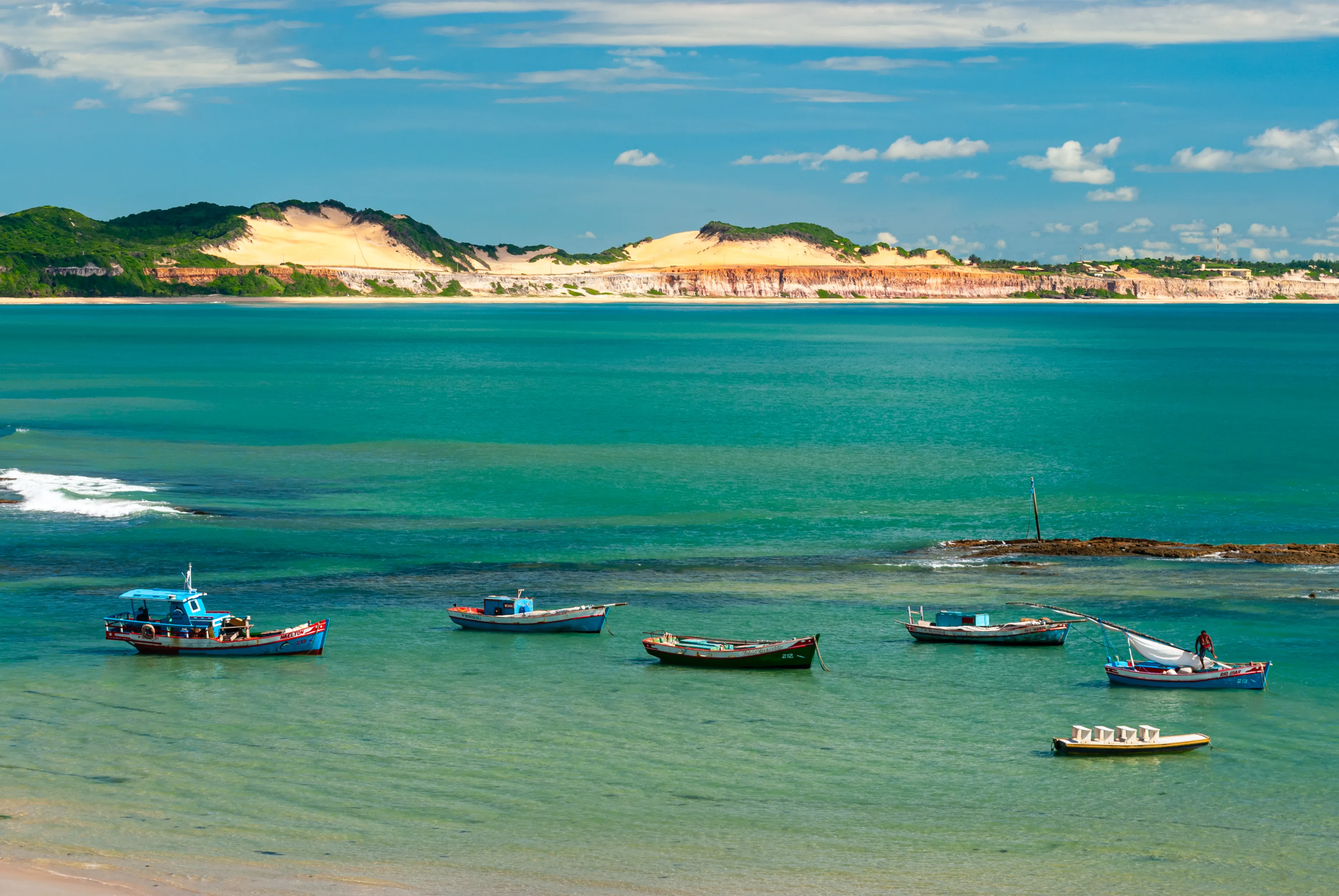 Pipa beach, Tibau do Sul, near Natal, Rio Grande do Norte, Brazil on May 7, 2008. Fisherman's boats anchored in the emerald sea on a sunny day.