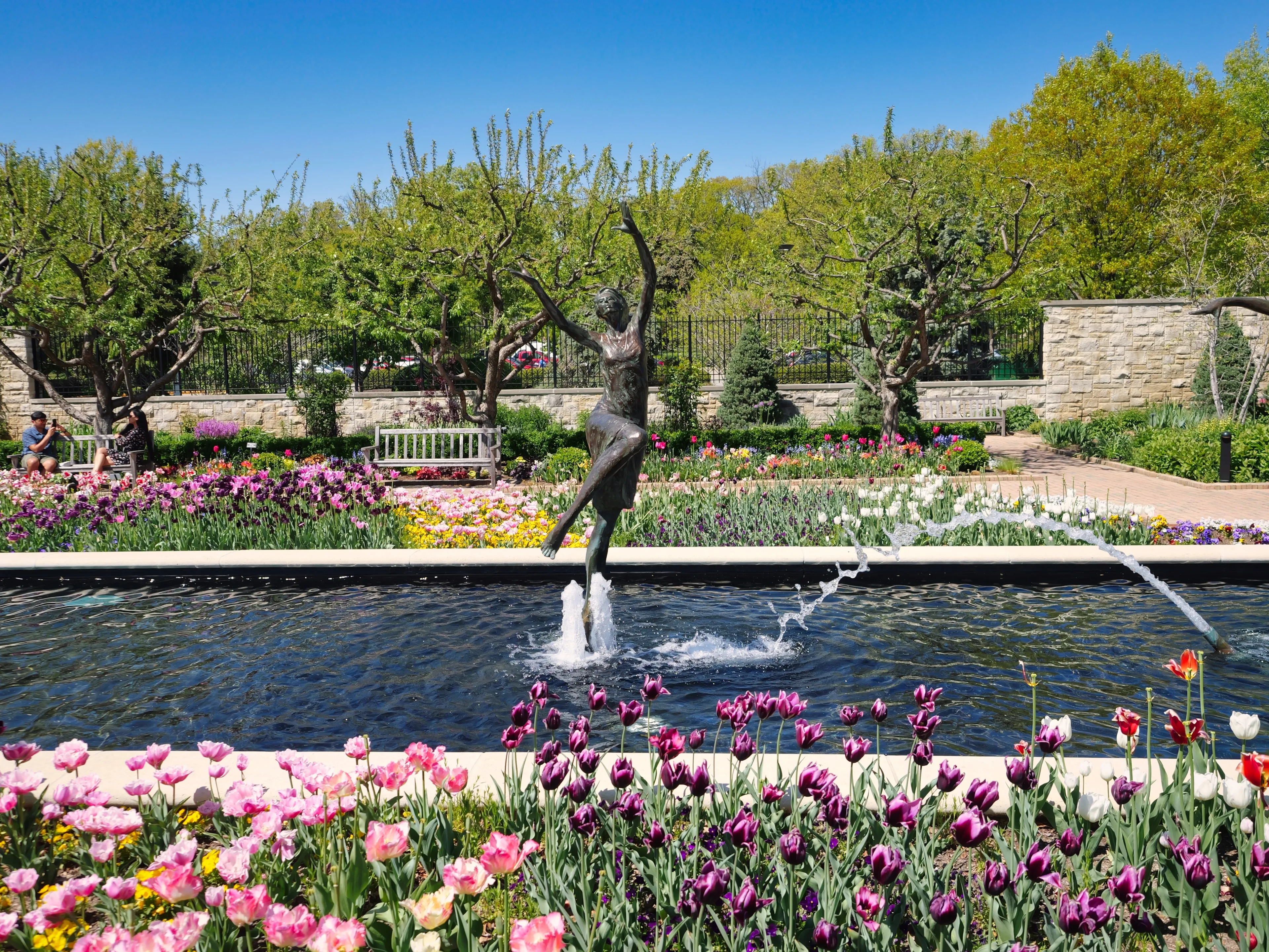 Kansas City, Missouri - April 29, 2023: Female statues in the tulip garden at Kauffman Gardens