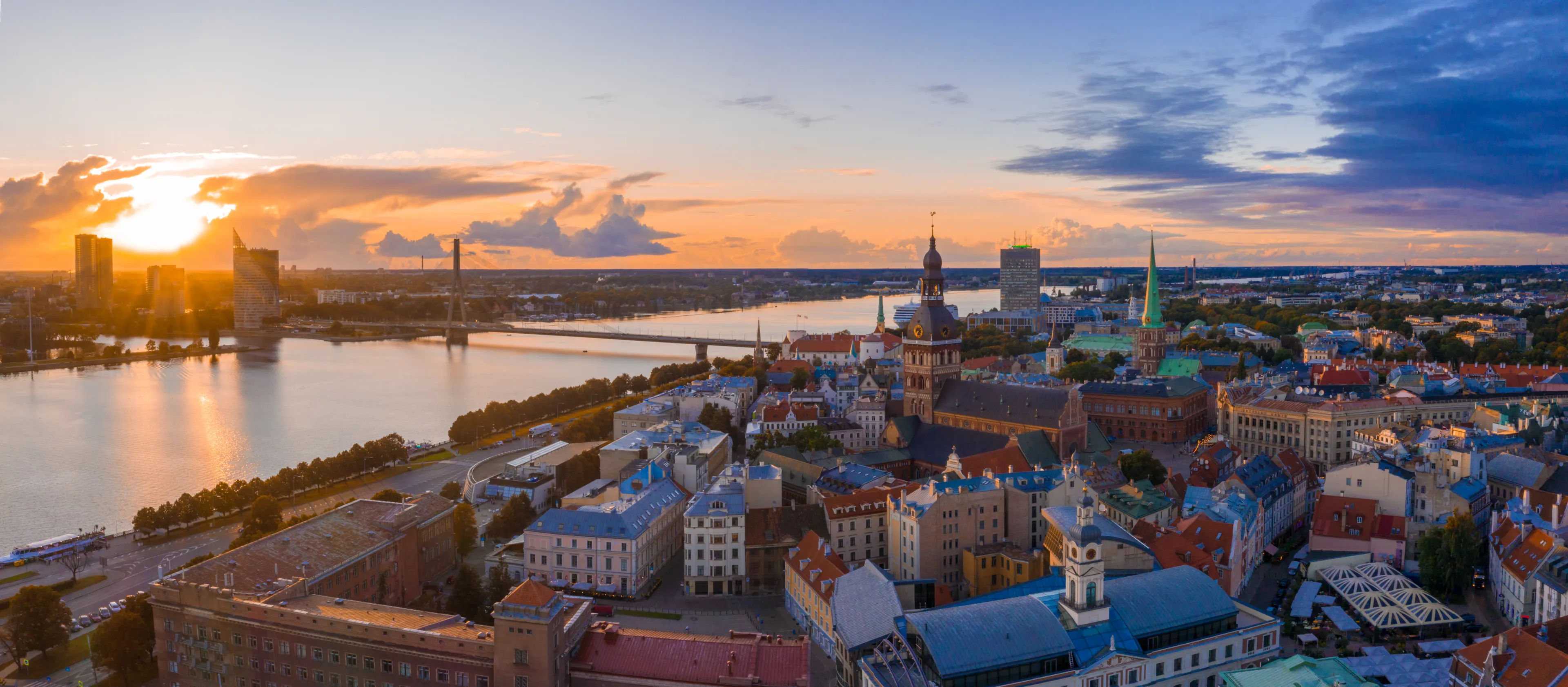 Magical stormy sunset over Riga old town - the capital of Latvia. Stormu clouds forming in the sky. Beautiful Riga at sunset.