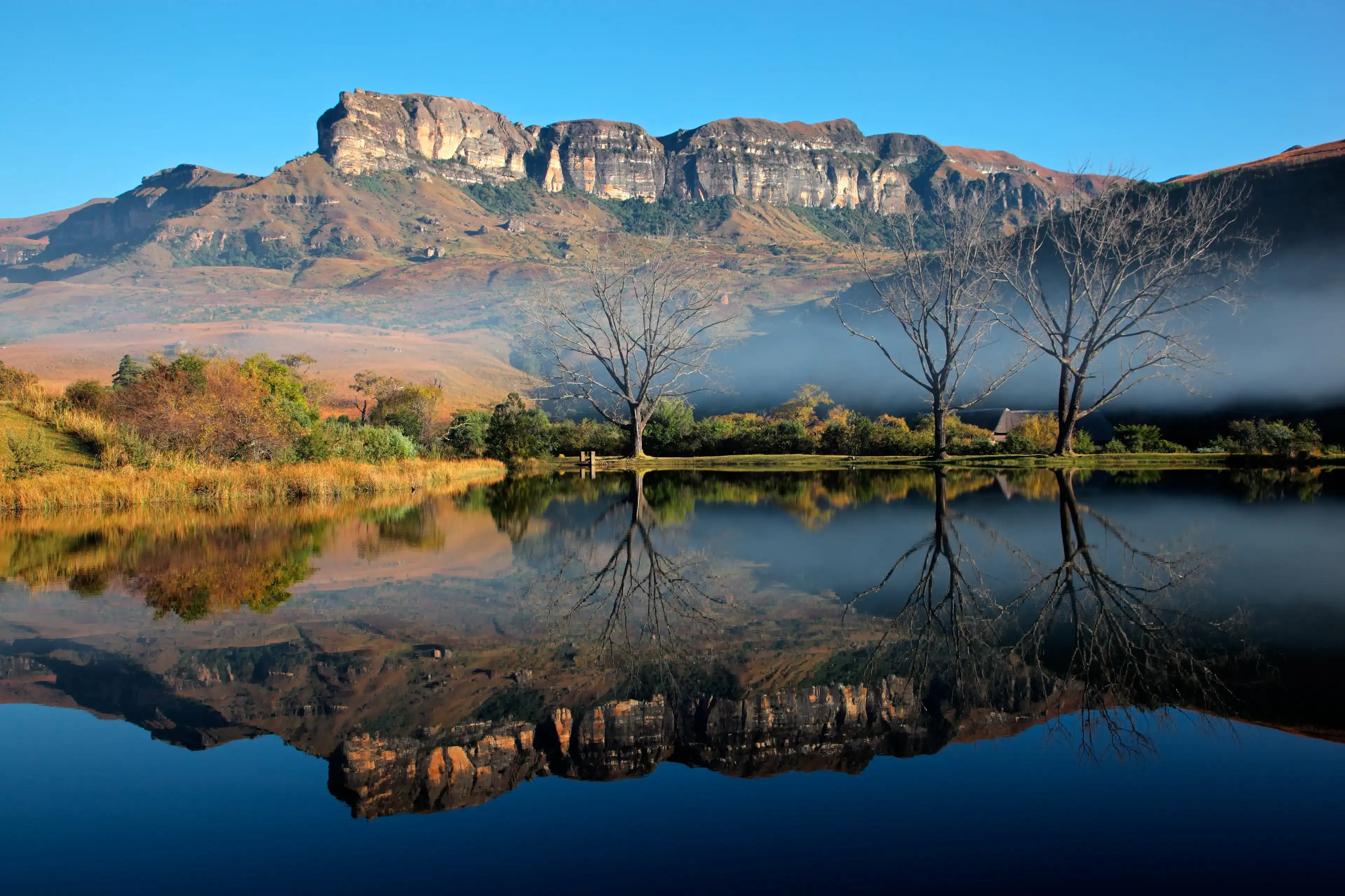 Sandstone mountains with symmetrical reflection in water, Royal Natal National Park, South Africa Sandstone mountains with symmetrical reflection in water, Royal Natal National Park, South Africa