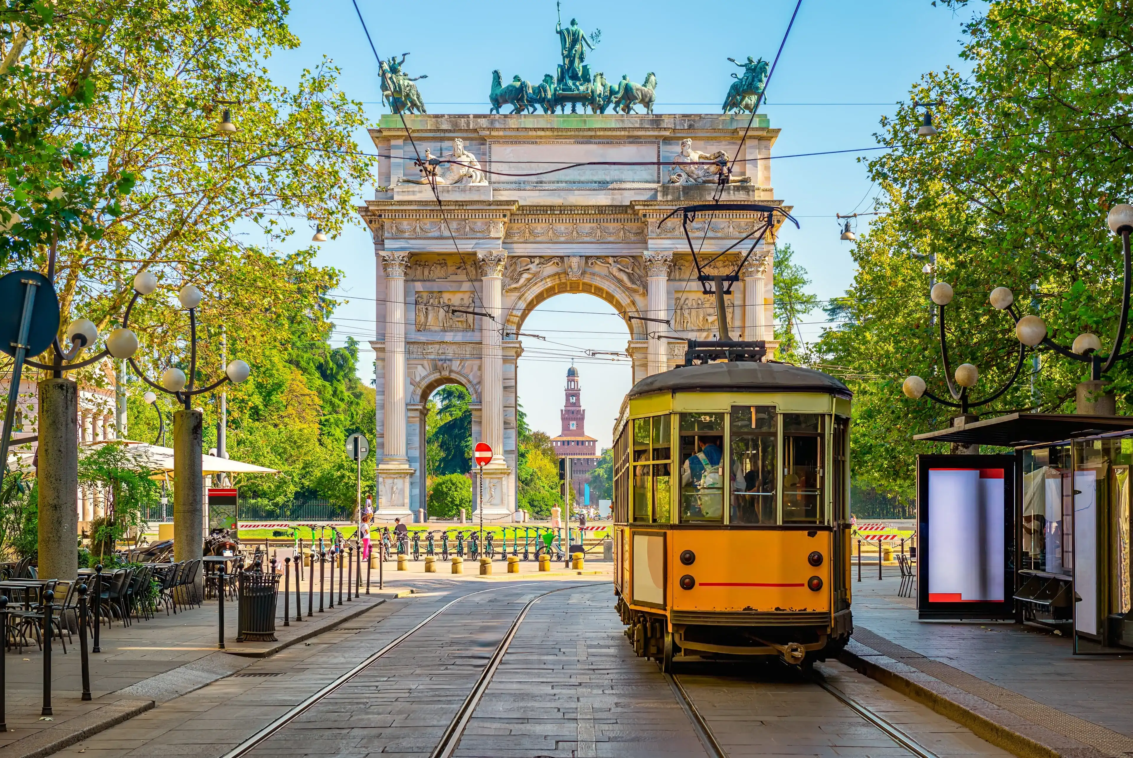 View of the Peace Arch with yellow tram in Milan, Italy View of the Peace Arch with yellow tram in Milan, Italy