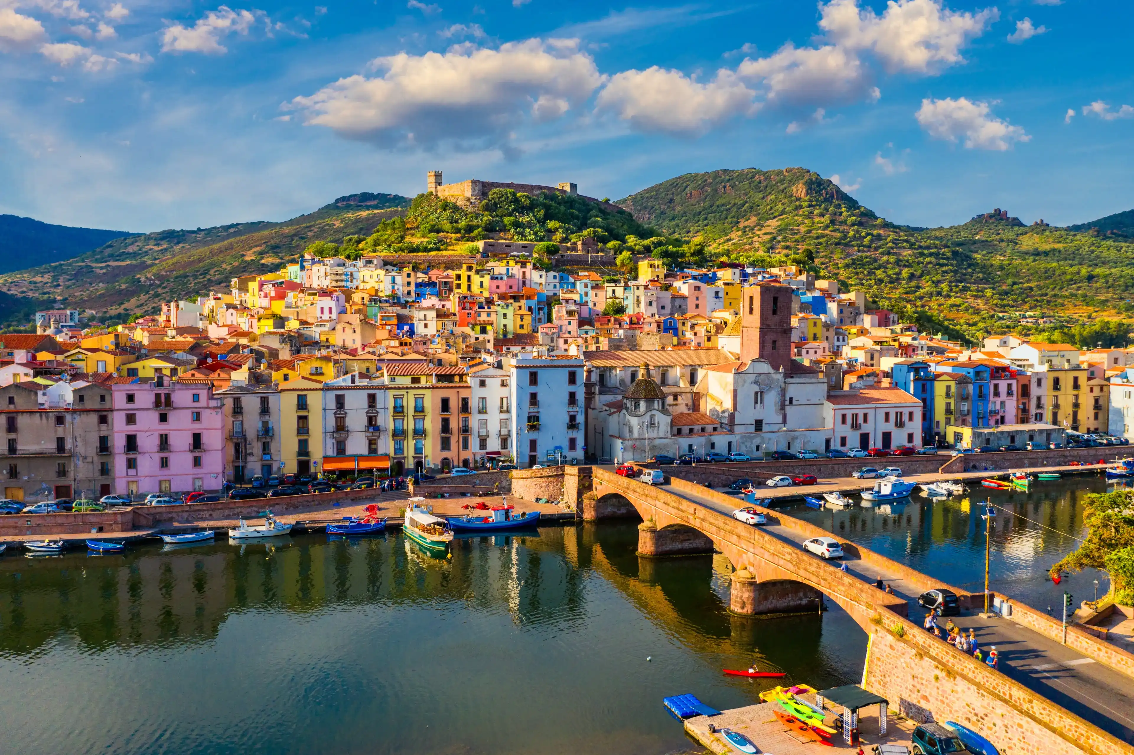 Aerial view of the beautiful village of Bosa with colored houses and a medieval castle. Bosa is located in the north-wesh of Sardinia, Italy. Aerial view of colorful houses in Bosa village, Sardegna. Aerial view of the beautiful village of Bosa with colored houses and a medieval castle. Bosa is located in the north-wesh of Sardinia, Italy. Aerial view of colorful houses in Bosa village, Sardegna.