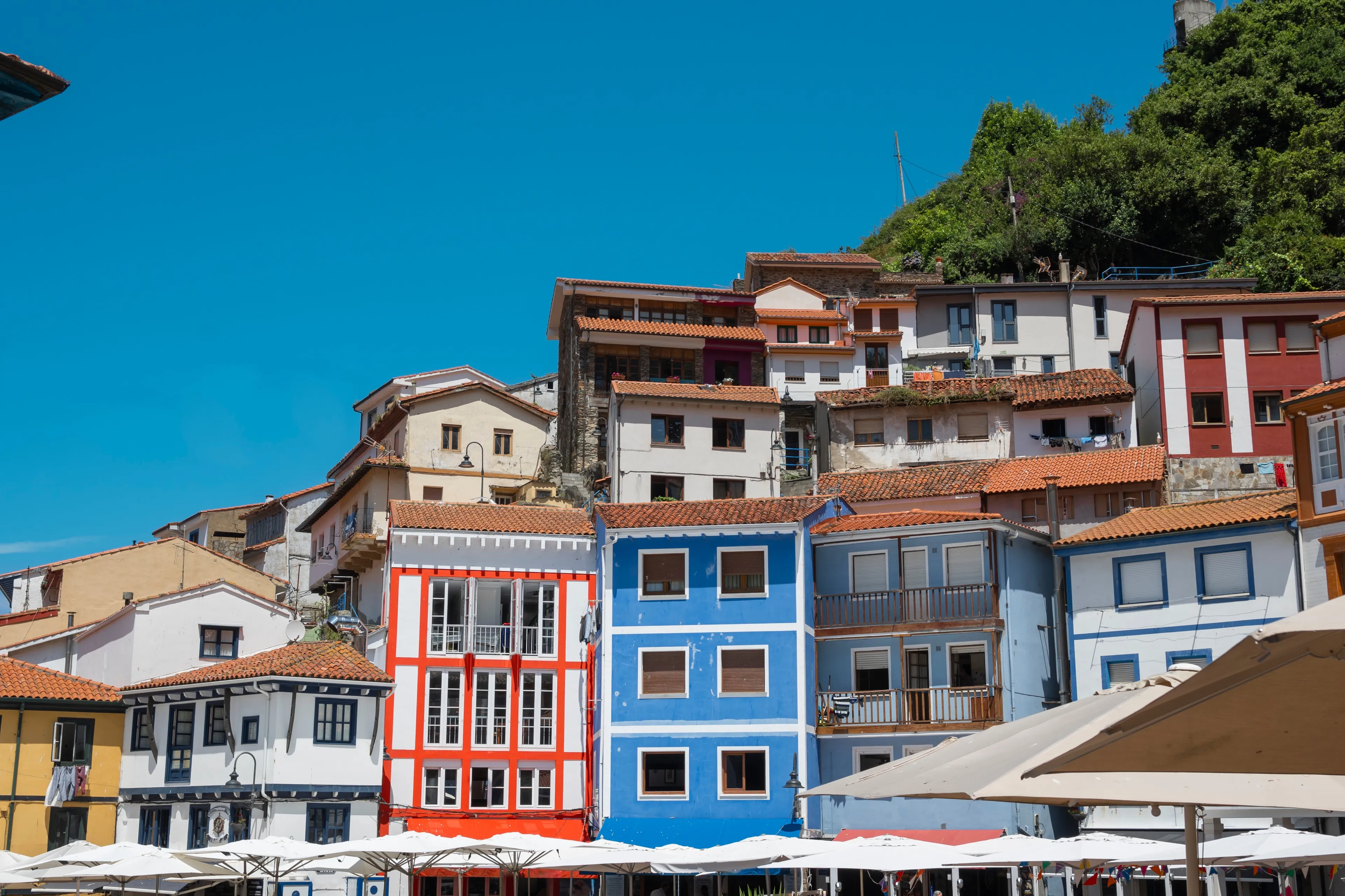 View of the Plaza de la Marina with its traditional colorful houses in the beautiful fishing village of Cudillero, Spain