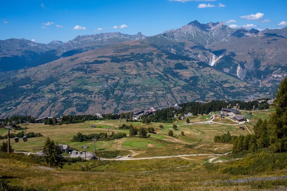 Bourg-saint-maurice, France - 22-08-2023: view of the golf courses in summer in the resort of Les Arcs 1600 in the French Alps.