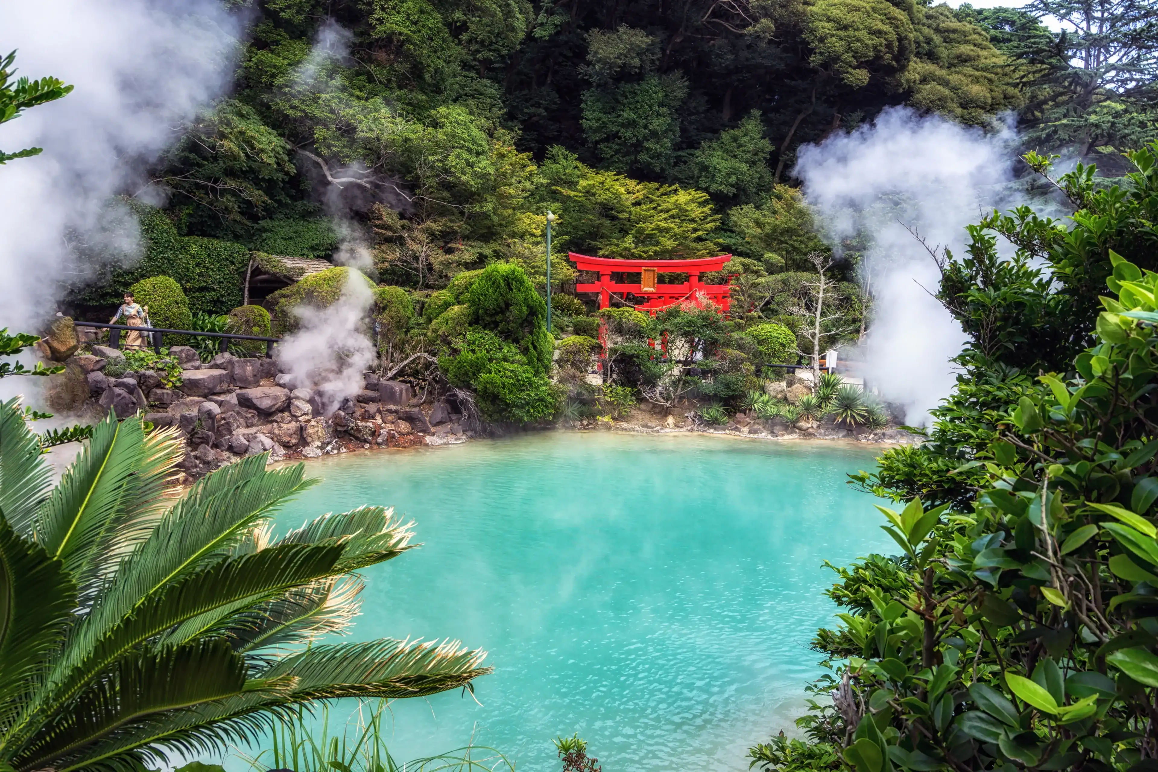 umi jigoku or sea hell taken in beppu with steamy hot springs geyser steaming off the cobalt water. Red torii gates nearby the geyser. Taken in Beppu, Japan umi jigoku or sea hell taken in beppu with steamy hot springs geyser steaming off the cobalt water. Red torii gates nearby the geyser. Taken in Beppu, Japan