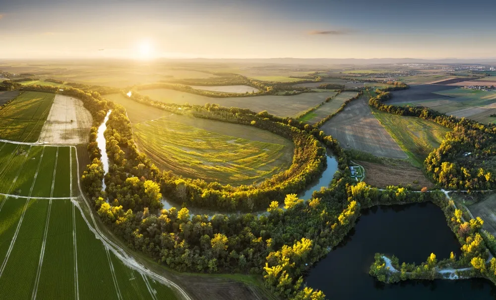 Sunset at Danube river meandering through romantic Slovakia countryside nature landscape Near Senec from drone.