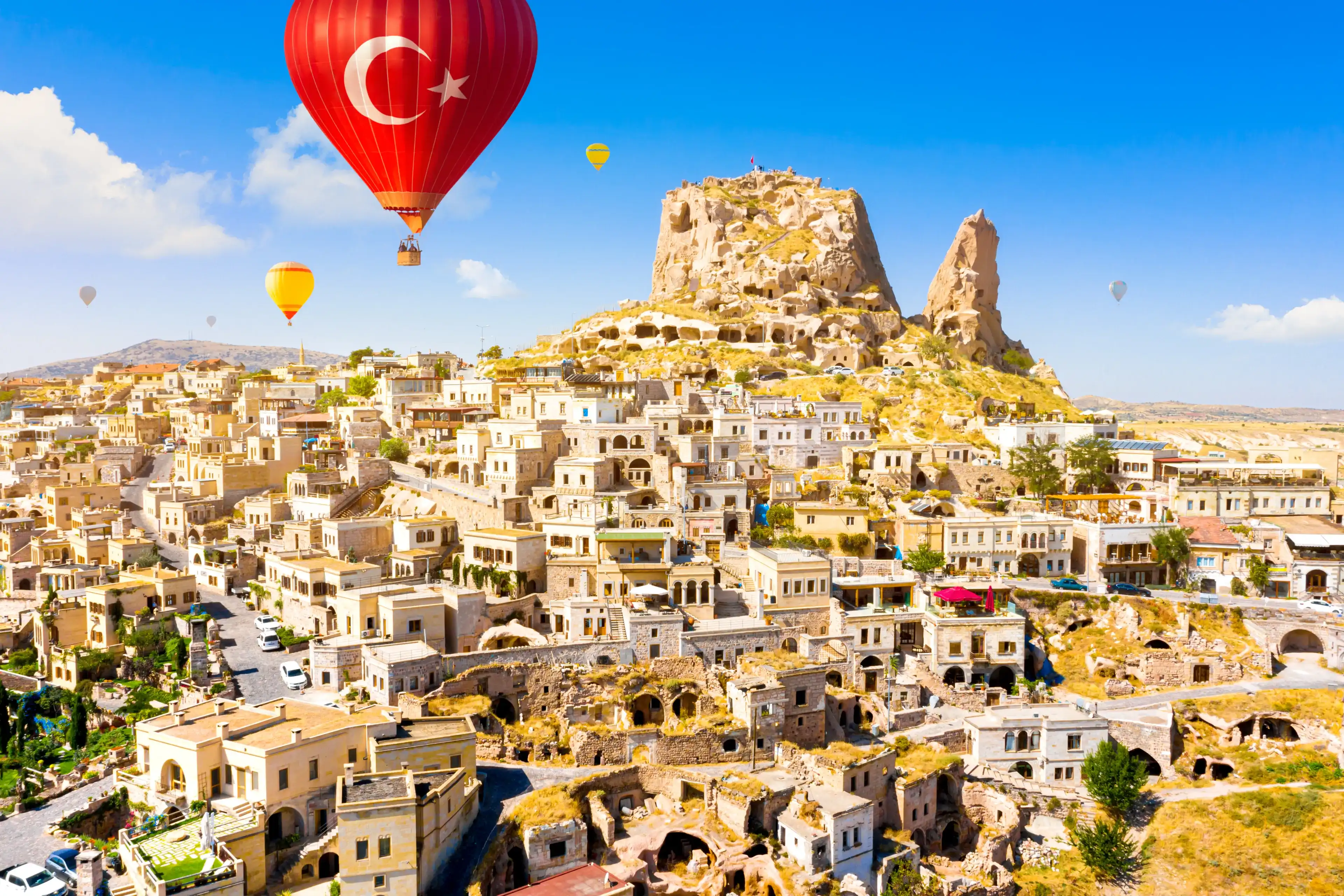 Hot air balloons flying over Uchisar Castle. Cappadocia. Nevsehir Province. Turkey Hot air balloons flying over Uchisar Castle. Cappadocia. Nevsehir Province. Turkey