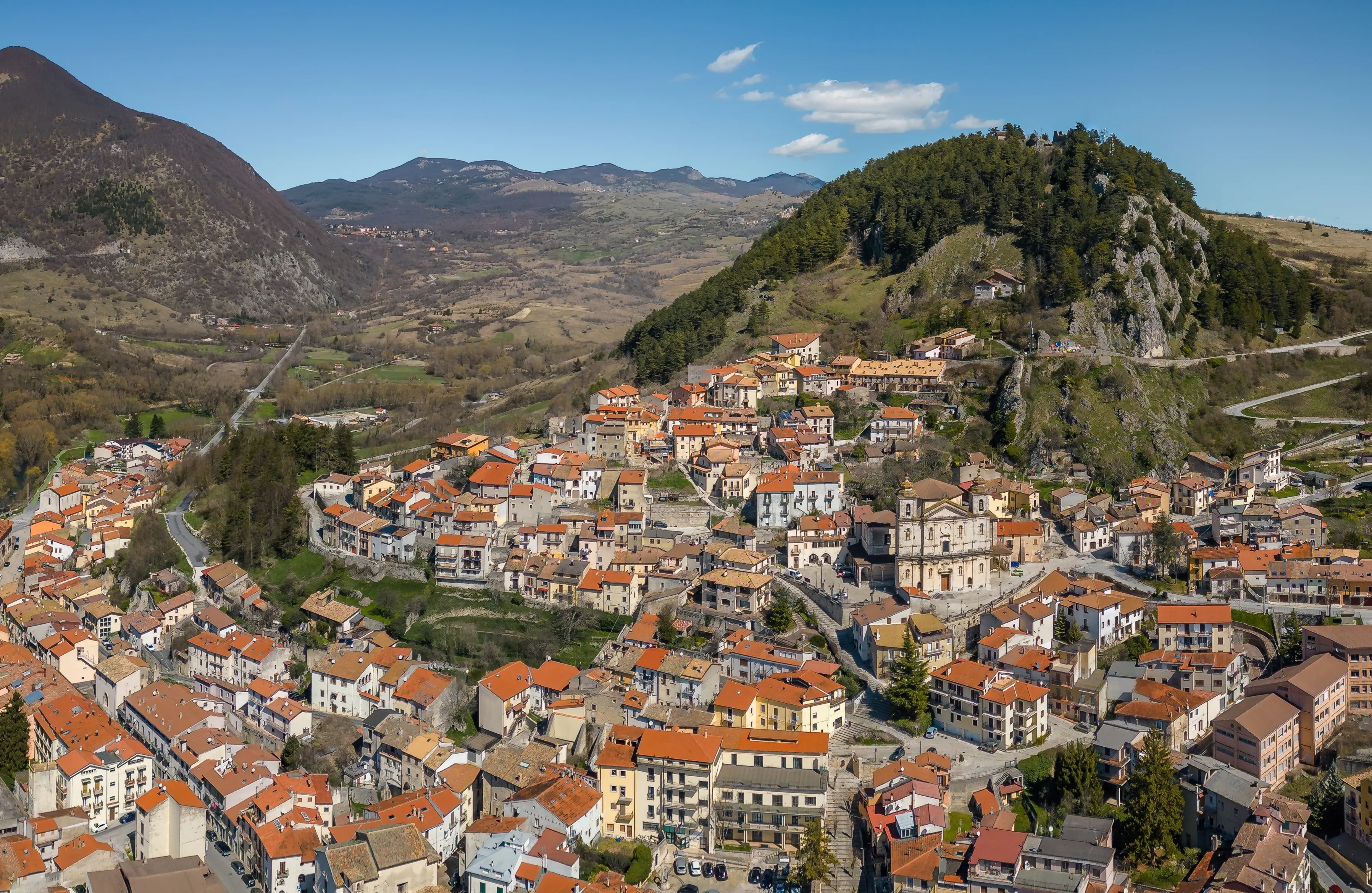 Aerial View of the old town and castle of Castel di Sangro on a sunny day - mountain italian village in the heart of Alto Sangro, Roccaraso ski area - Italian Appennine, L'Aquila, Abruzzo, Italy
