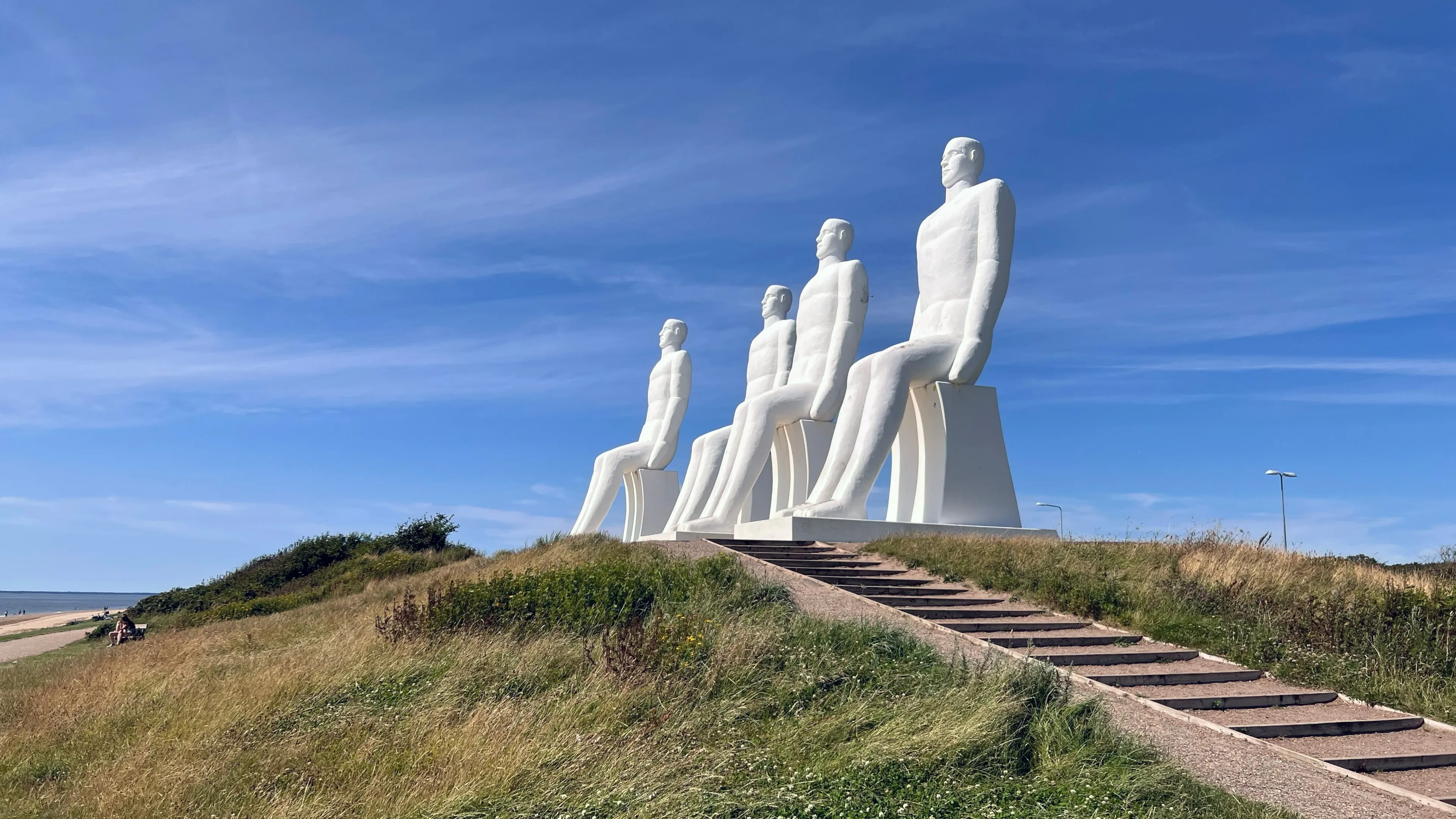 Esbjerg, Juttland, Denmark - July 19, 2024 - Man by the Sea, Large Sculptures by the Beautiful Beach of Esbjerg (De Fire Hvide Maend)