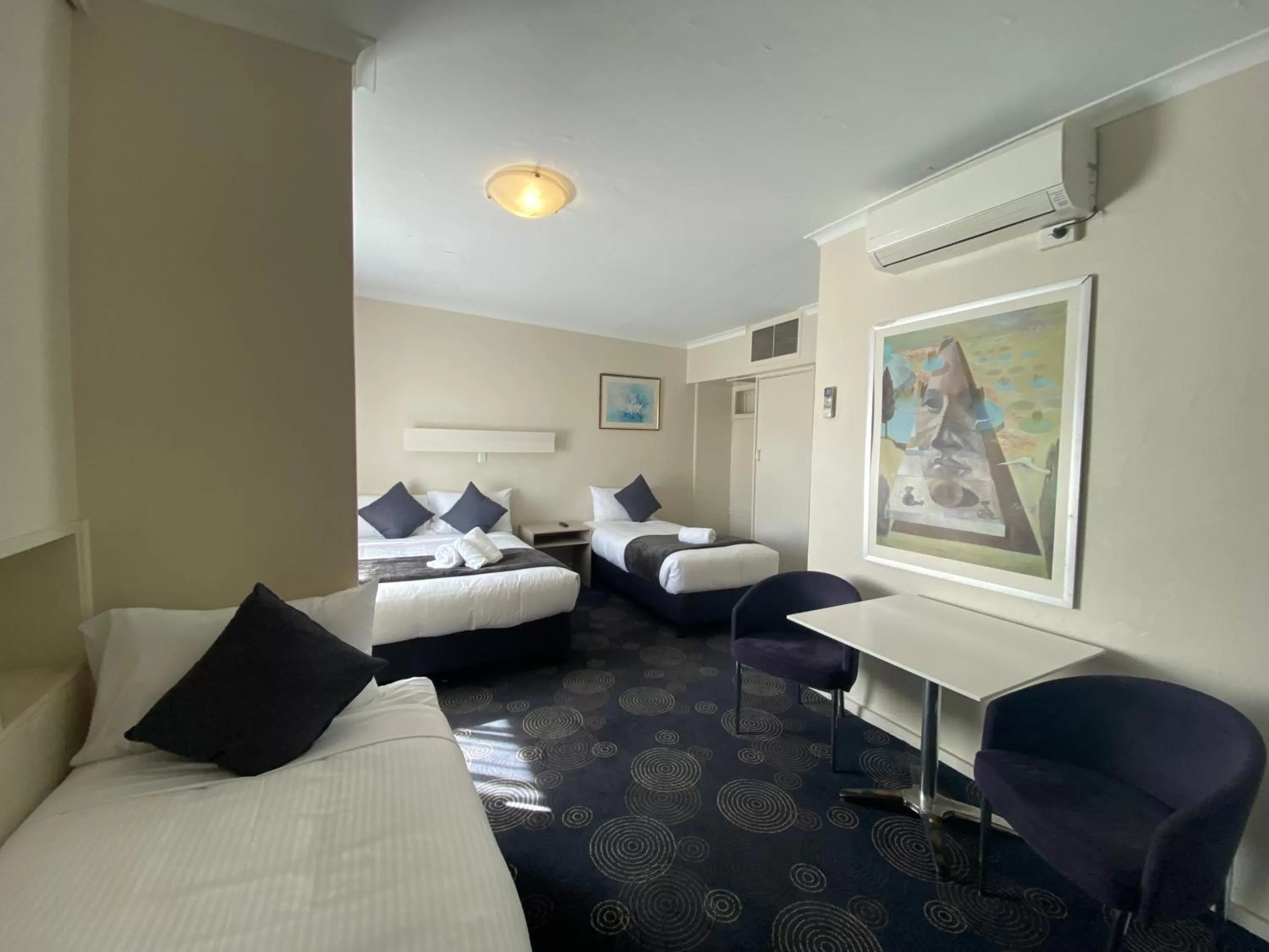 Bed in The Astor Hotel Motel