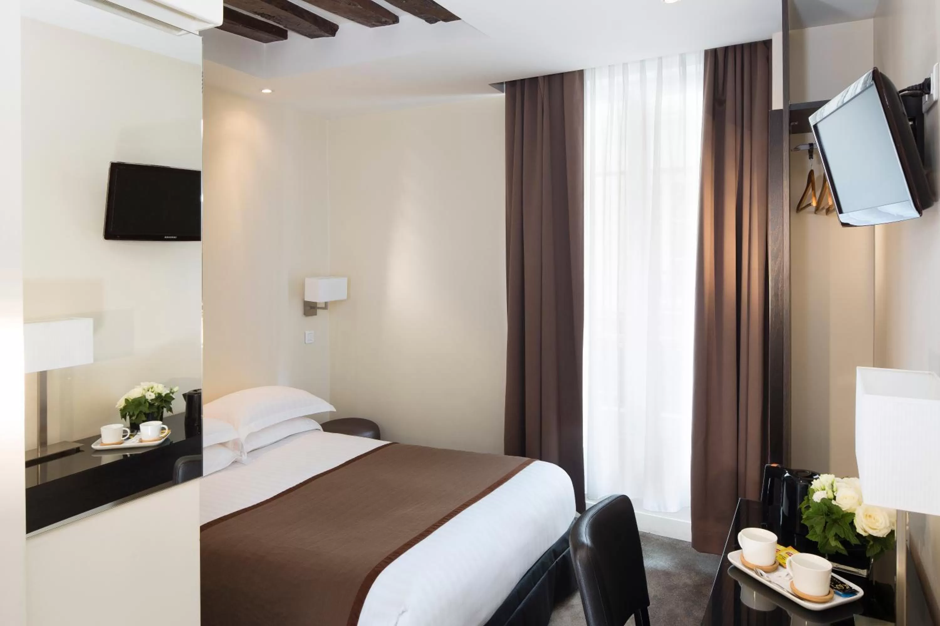 Bed in Lion d'Or Paris Hotel