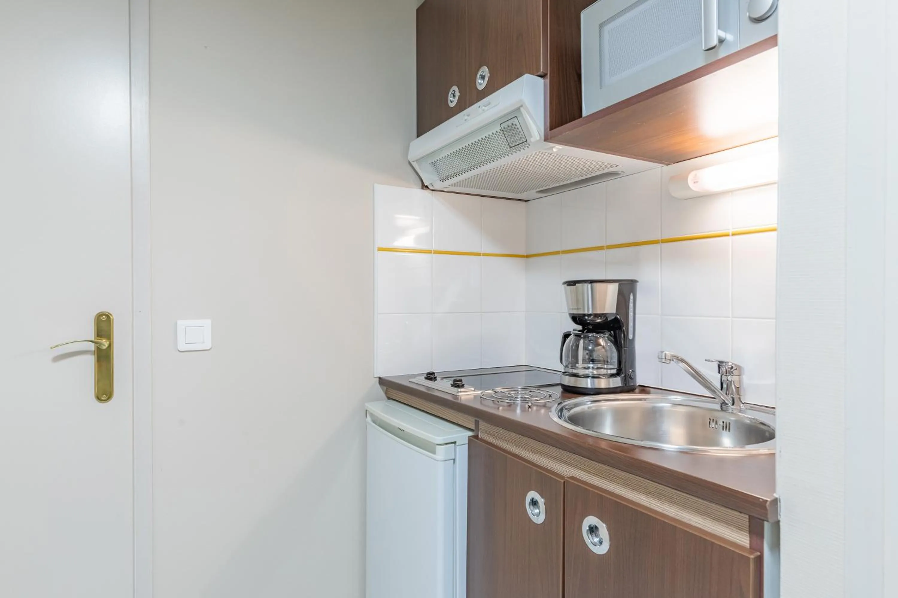 Kitchen or kitchenette in Appart'City Confort Agen Centre