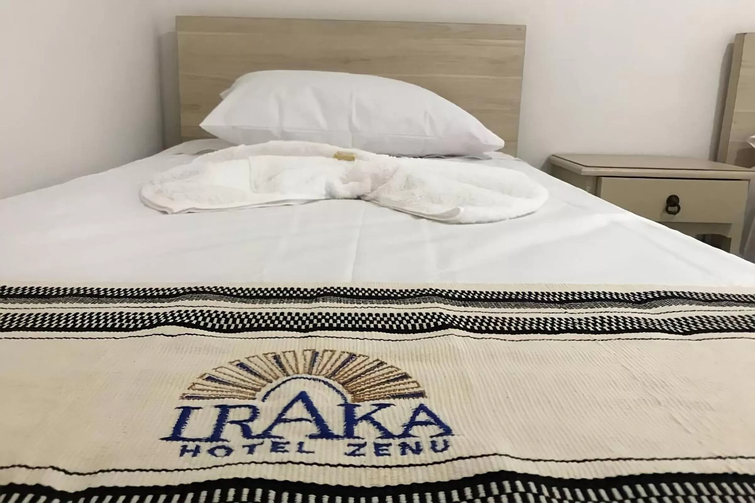 Bed in Hotel Iraka Zenu