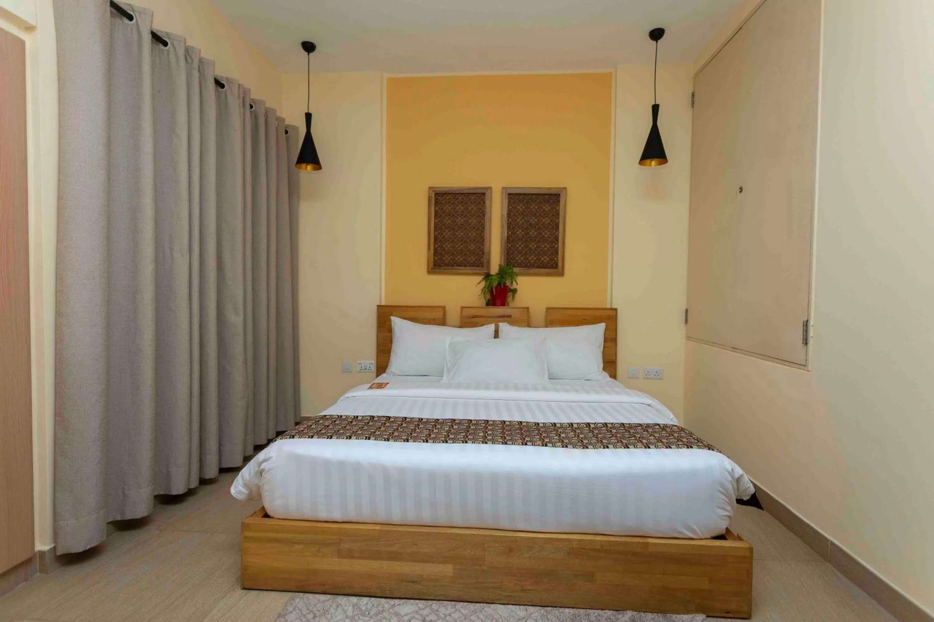 Bed in Roots Hotel Apartment