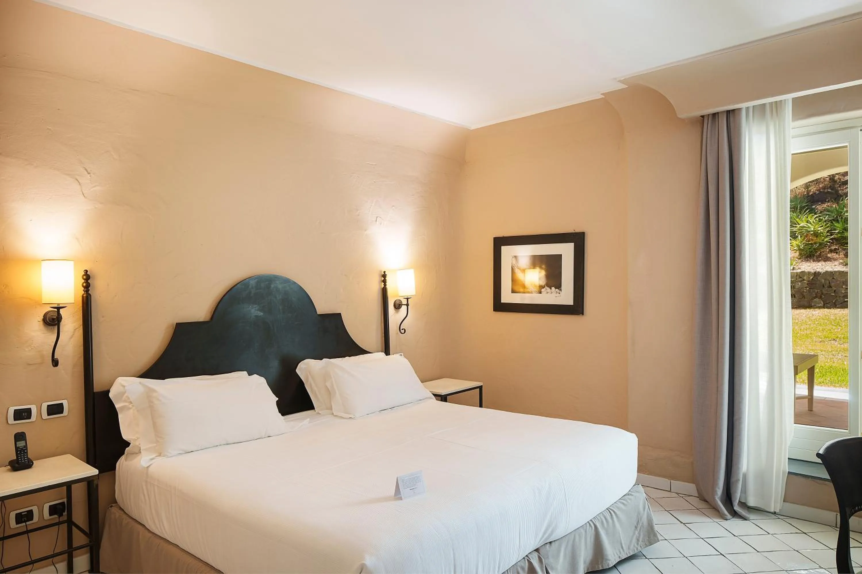 Bed in Therasia Resort Sea and SPA - The Leading Hotels of the World