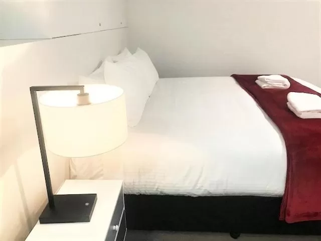 Bed in Sunrise Luxury Apartments