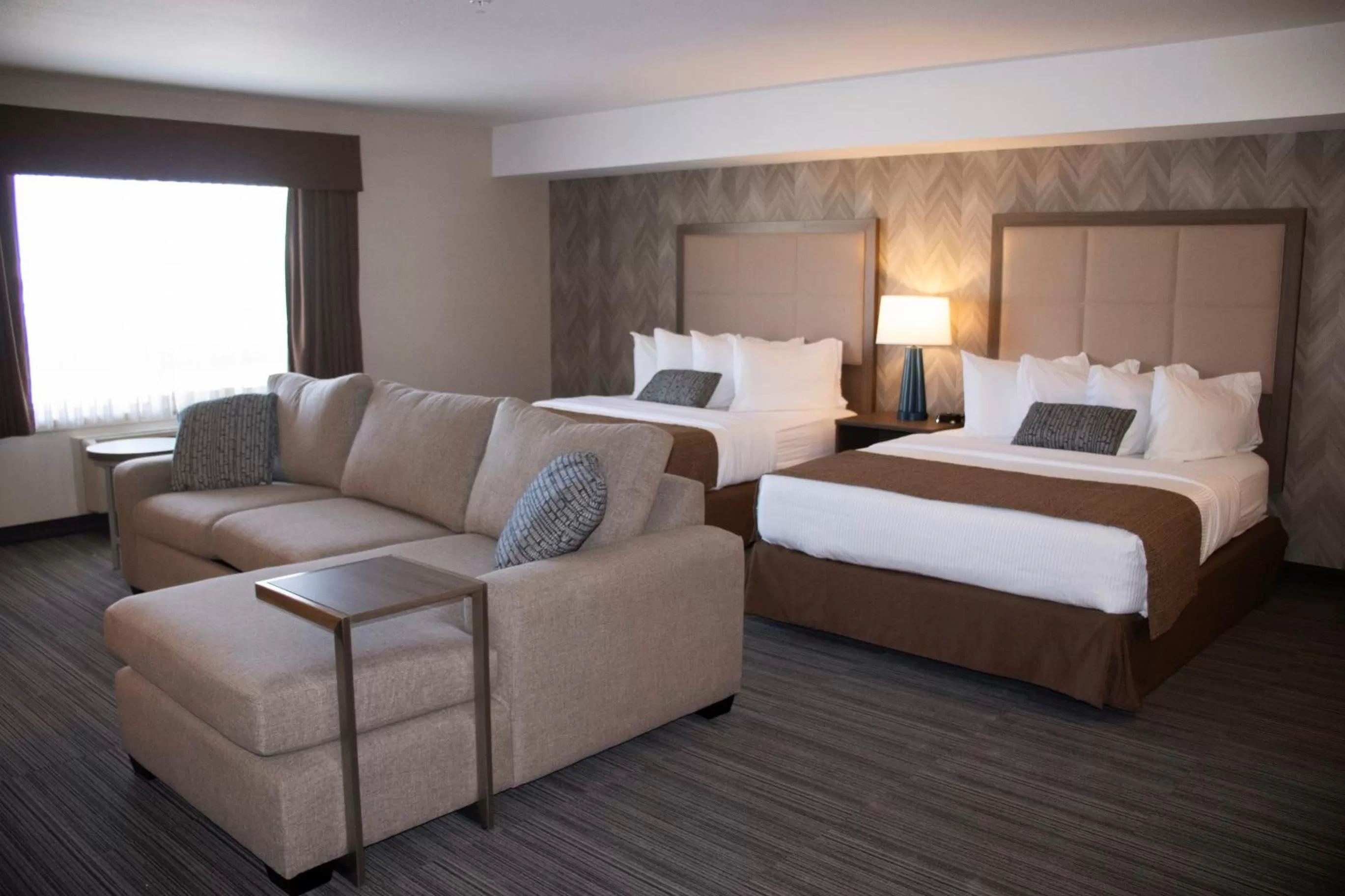 Seating area, Bed in Ramada by Wyndham Airdrie Hotel & Suites