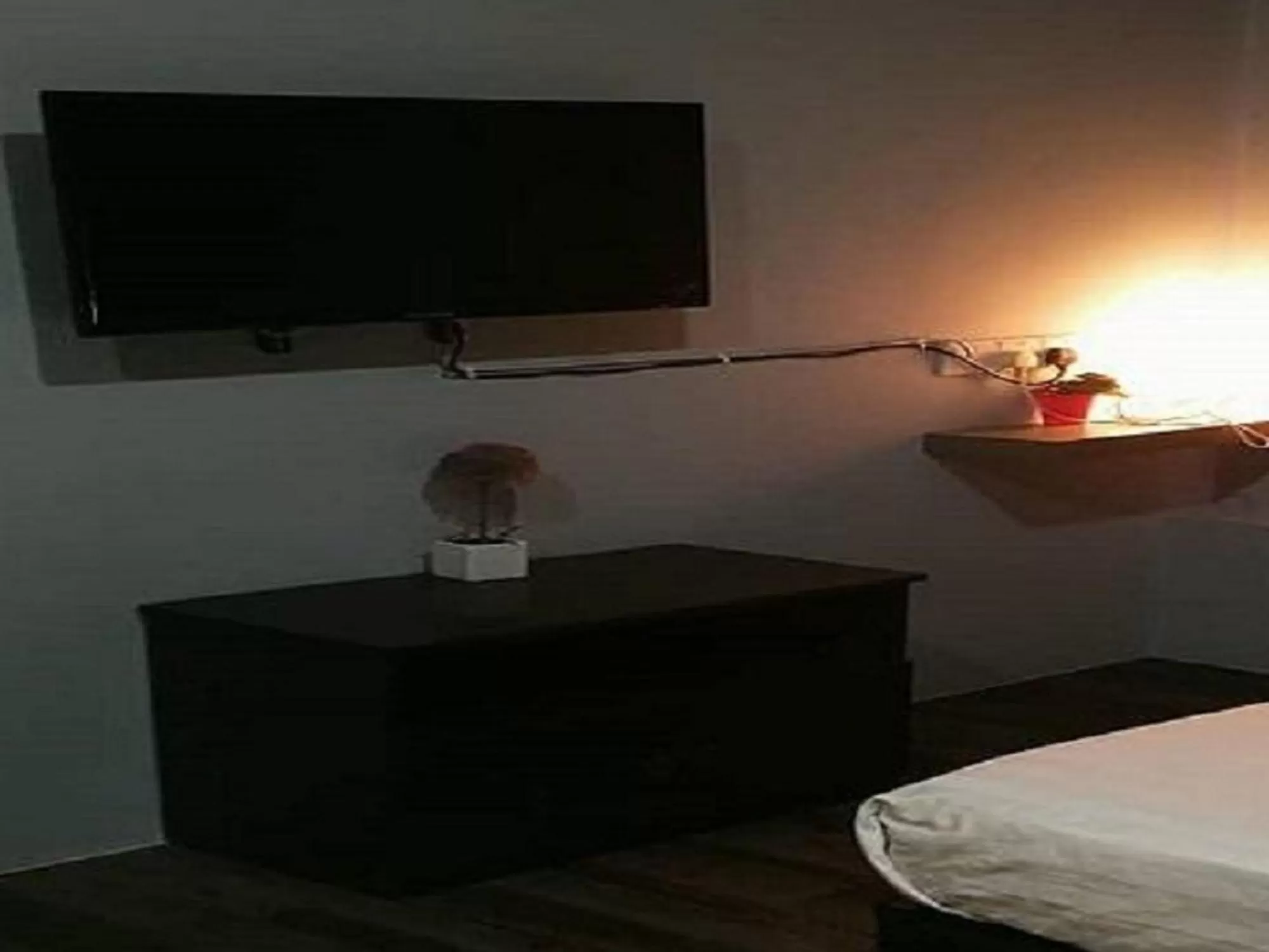 Communal lounge/ TV room, Bed in Lucky Hotel