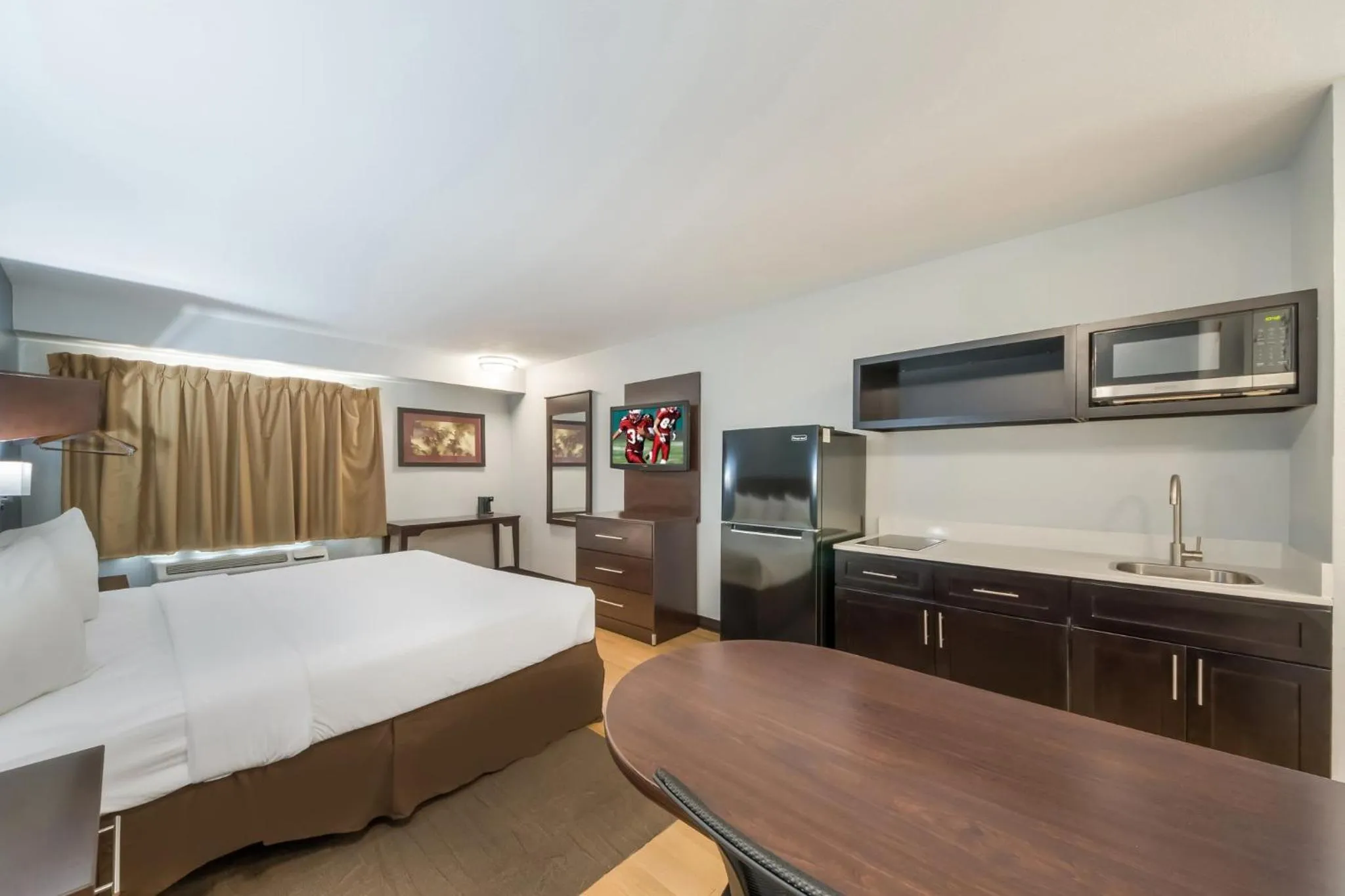 Bedroom, Bed in HomeTowne Studios by Red Roof San Antonio - SeaWorld Northwest