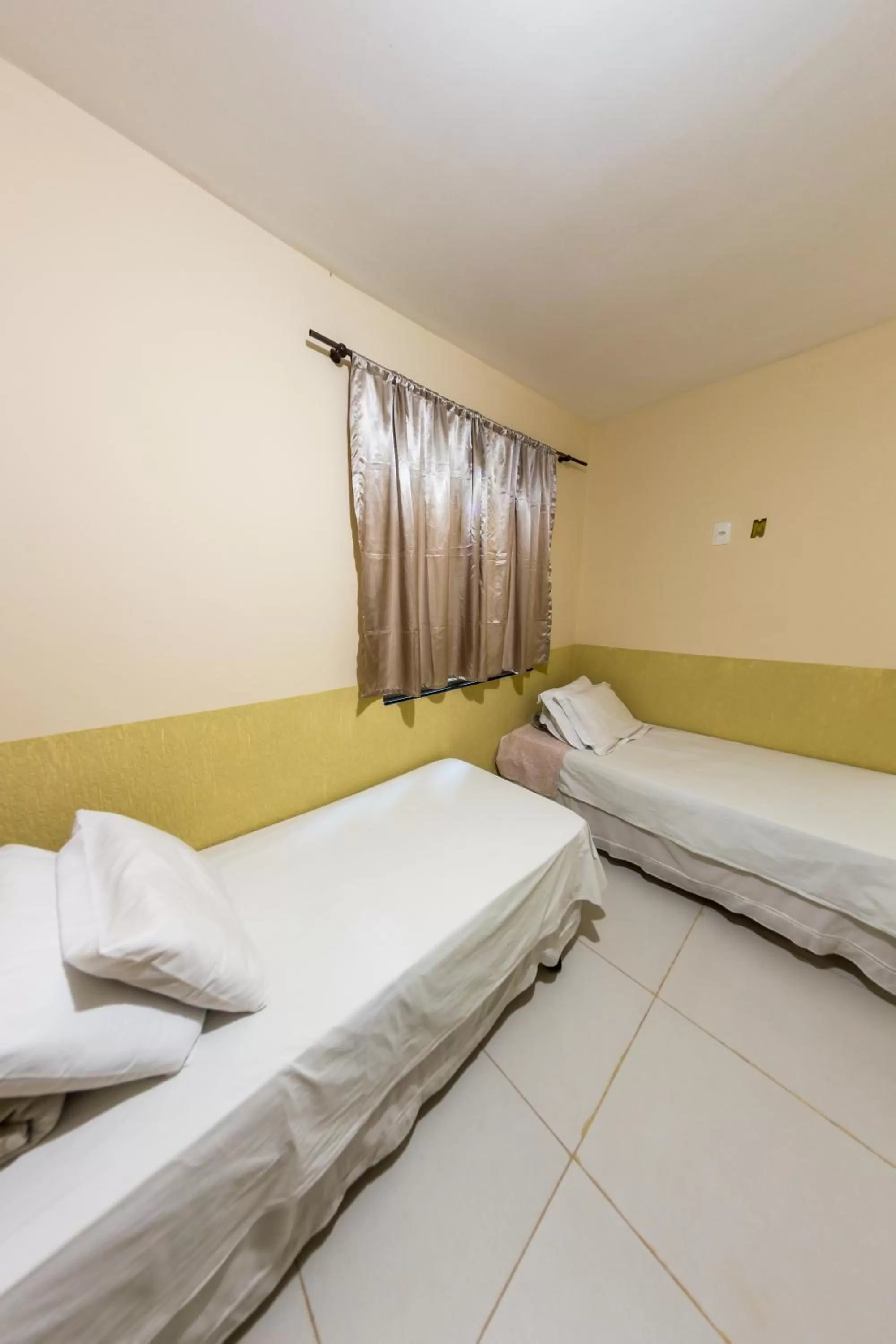 Bed in Pousada Jardim Brasília