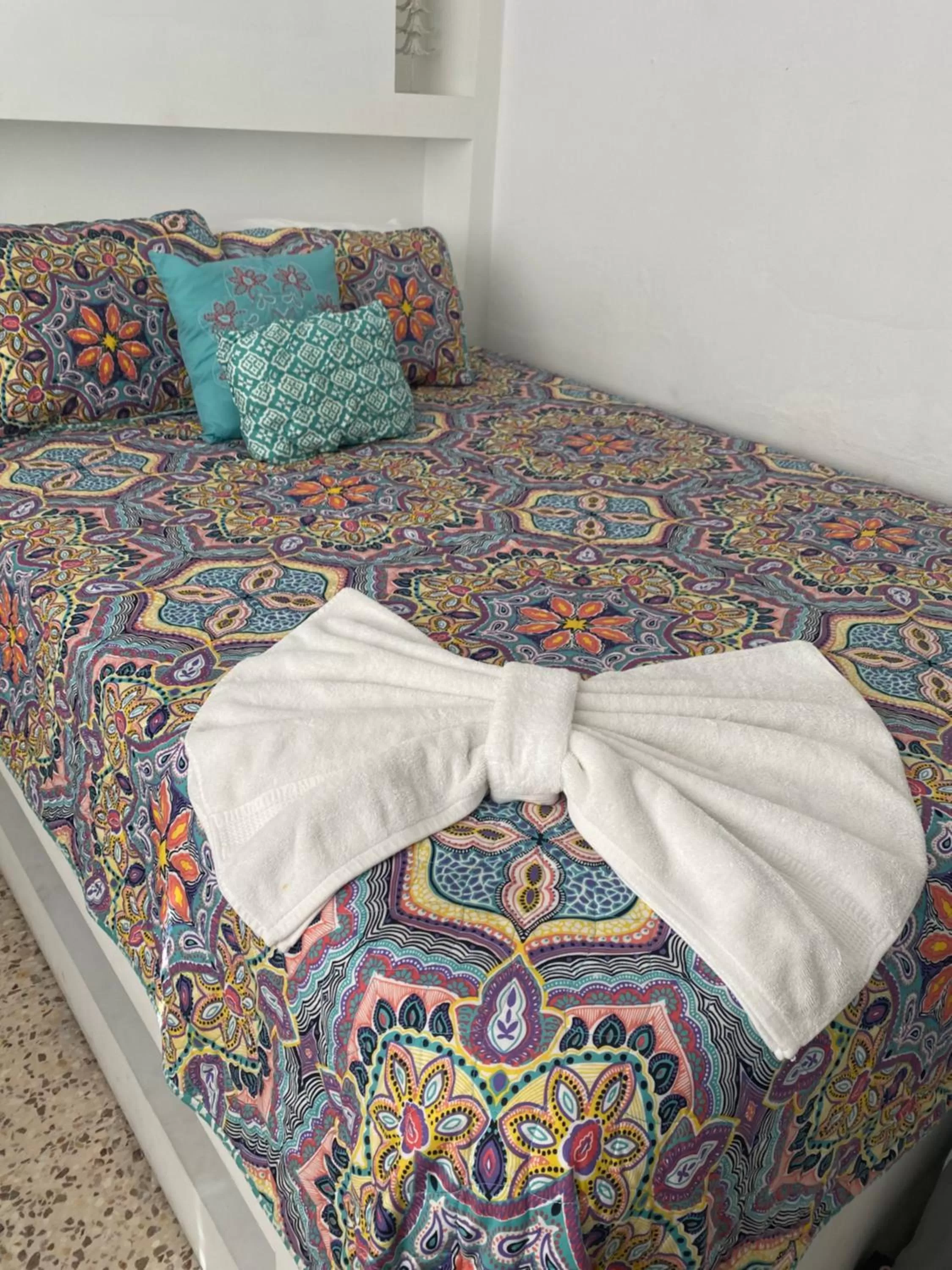 Bed in Itza-Bella Suites