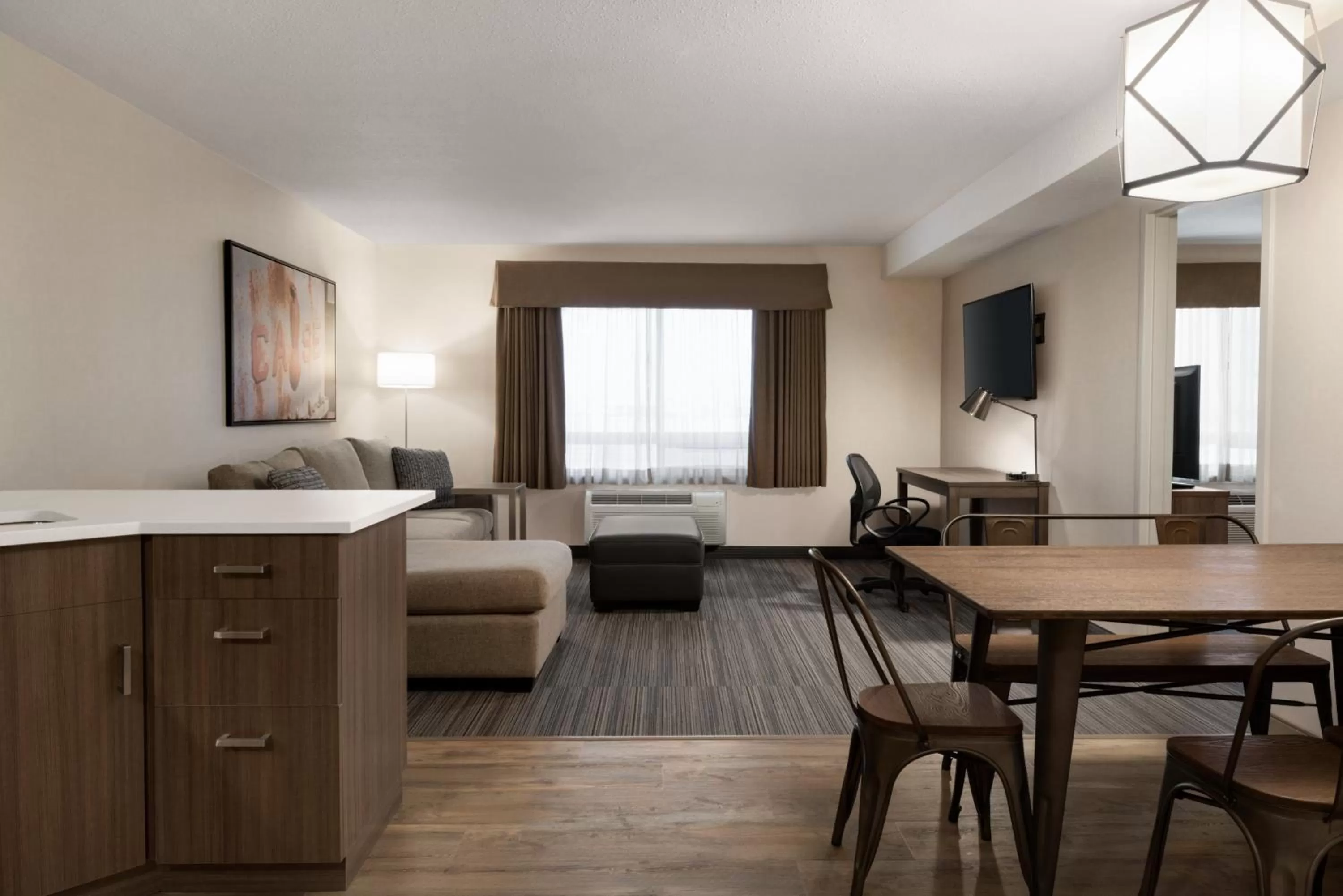 Living room, Bed in Ramada by Wyndham Airdrie Hotel & Suites