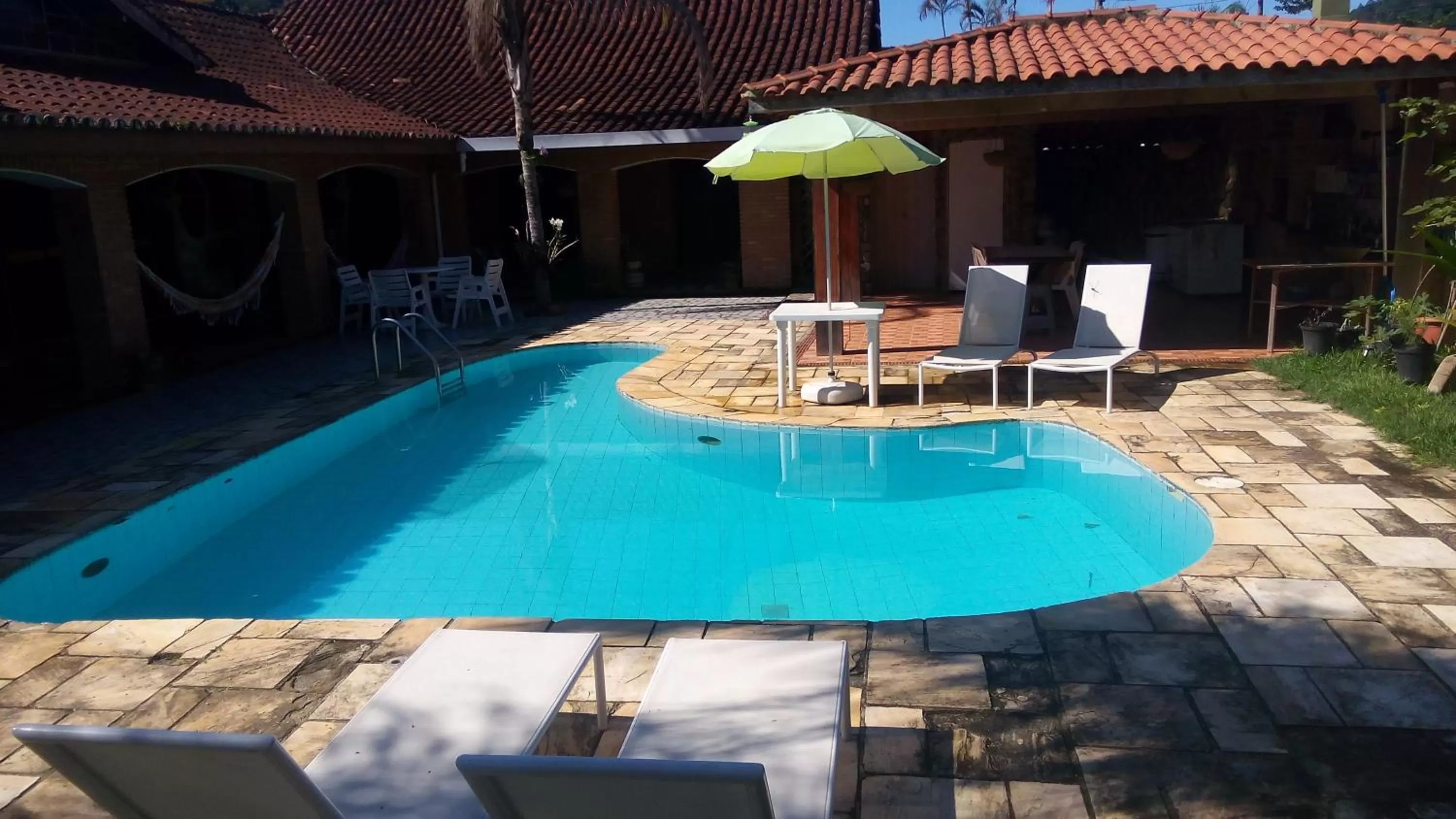 Swimming pool in Pousada Na Praia Ubatuba
