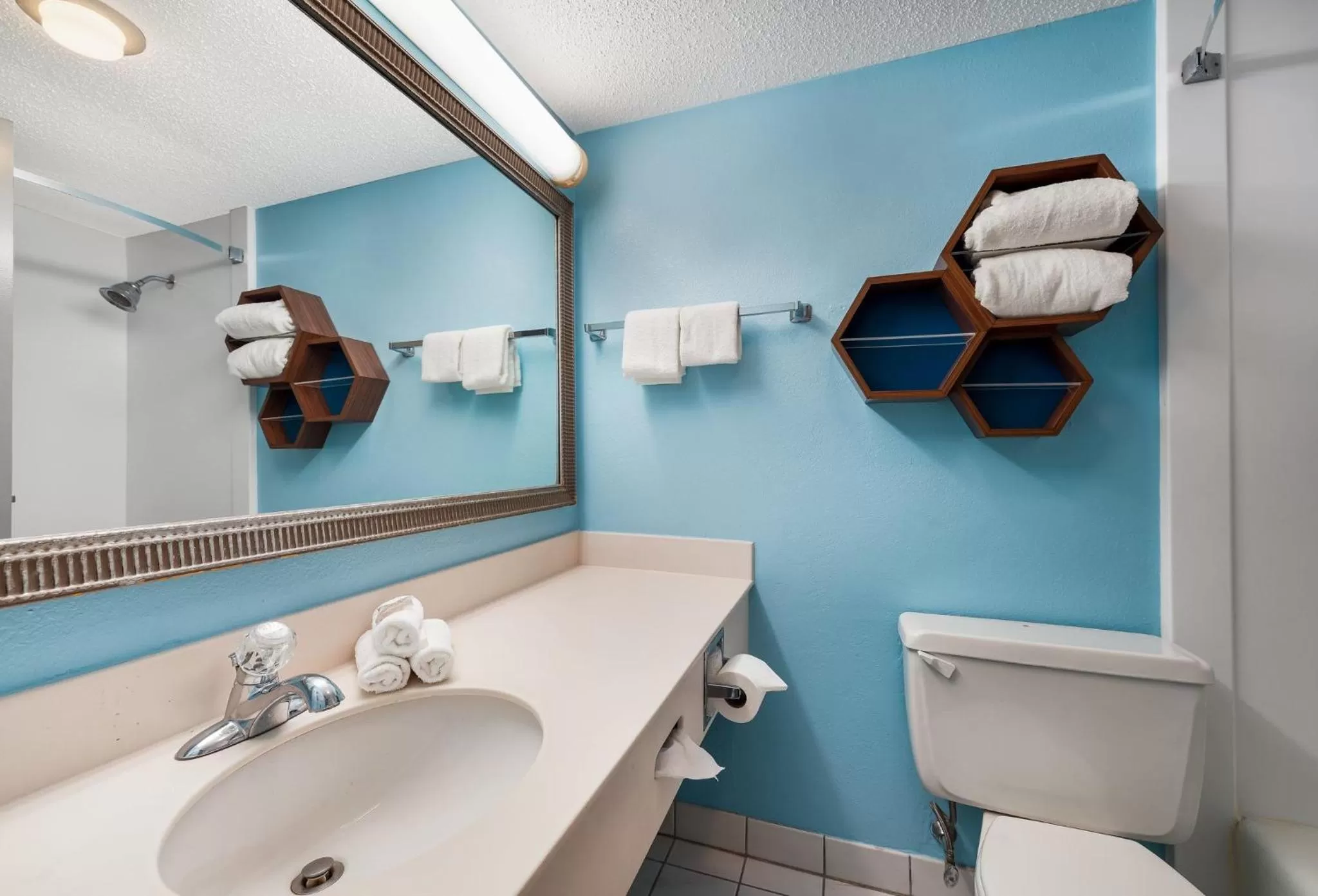 Bathroom in HomeTowne Studios by Red Roof Painted Post