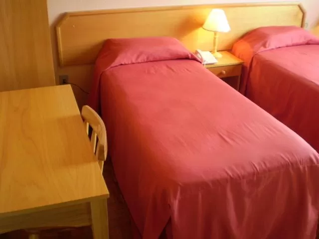 Bed in Hotel Gravataí Center