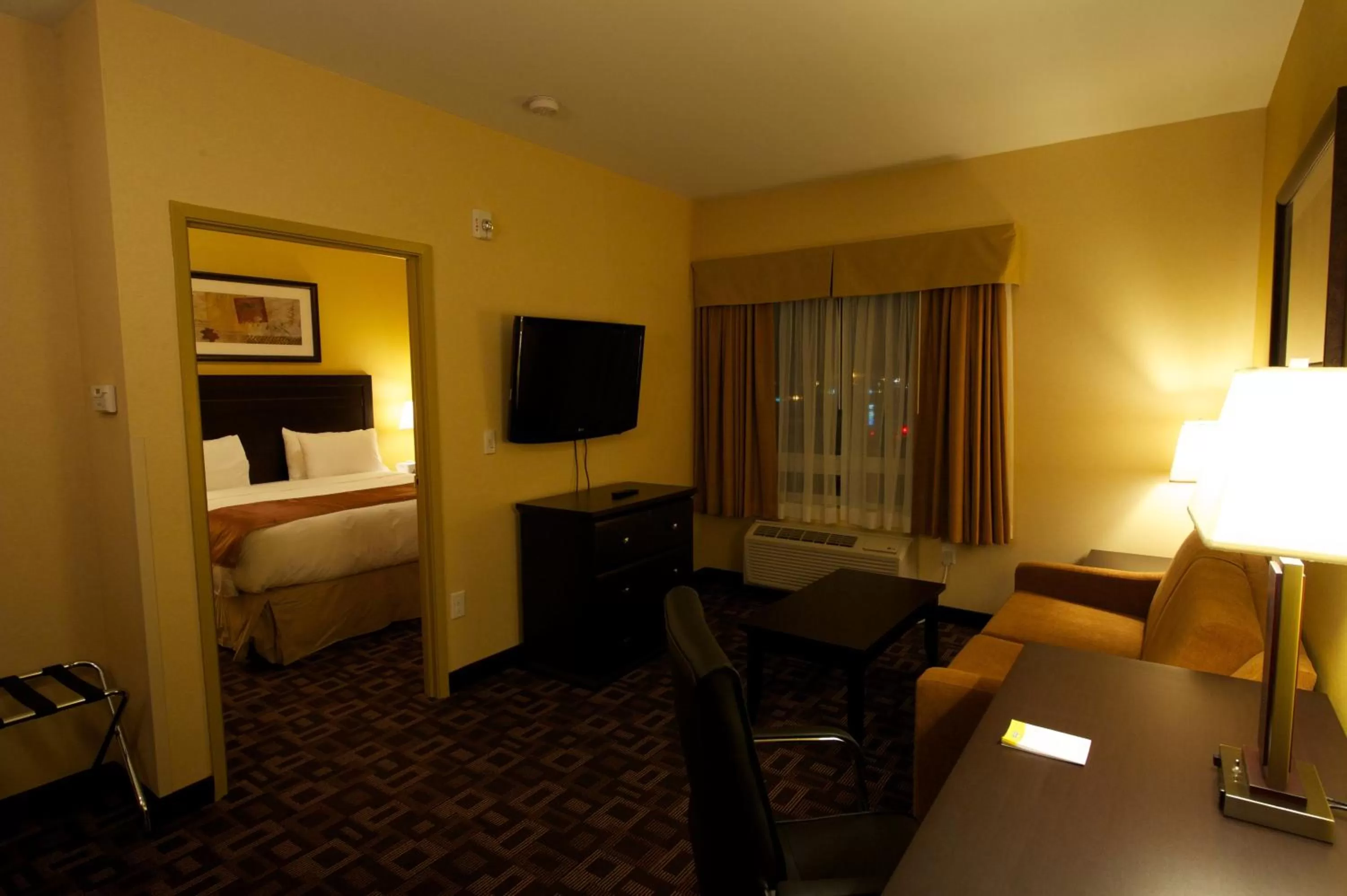 Seating area, Bed in Days Inn & Suites by Wyndham Winnipeg Airport Manitoba