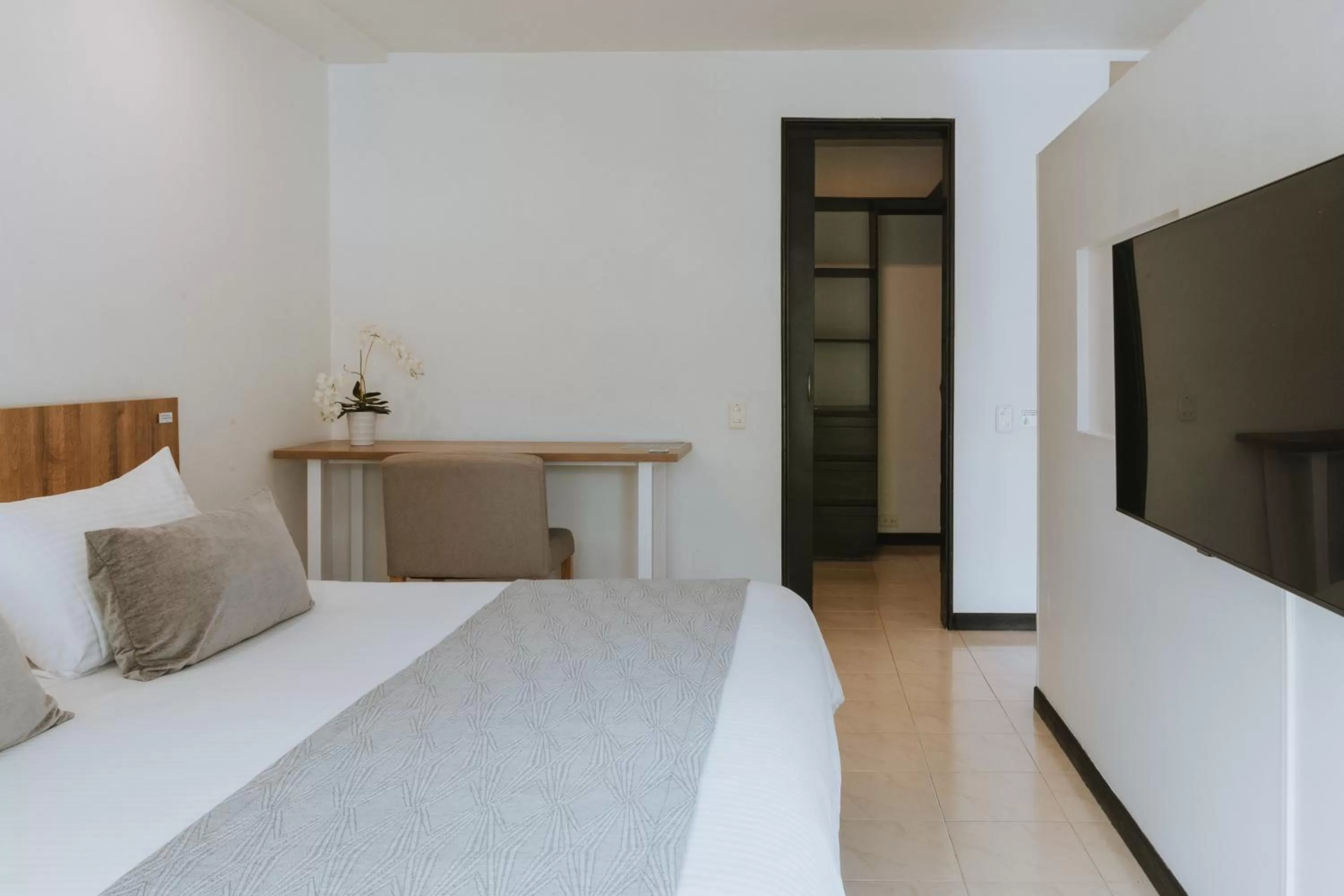 Bed in Travelers Orange Suites