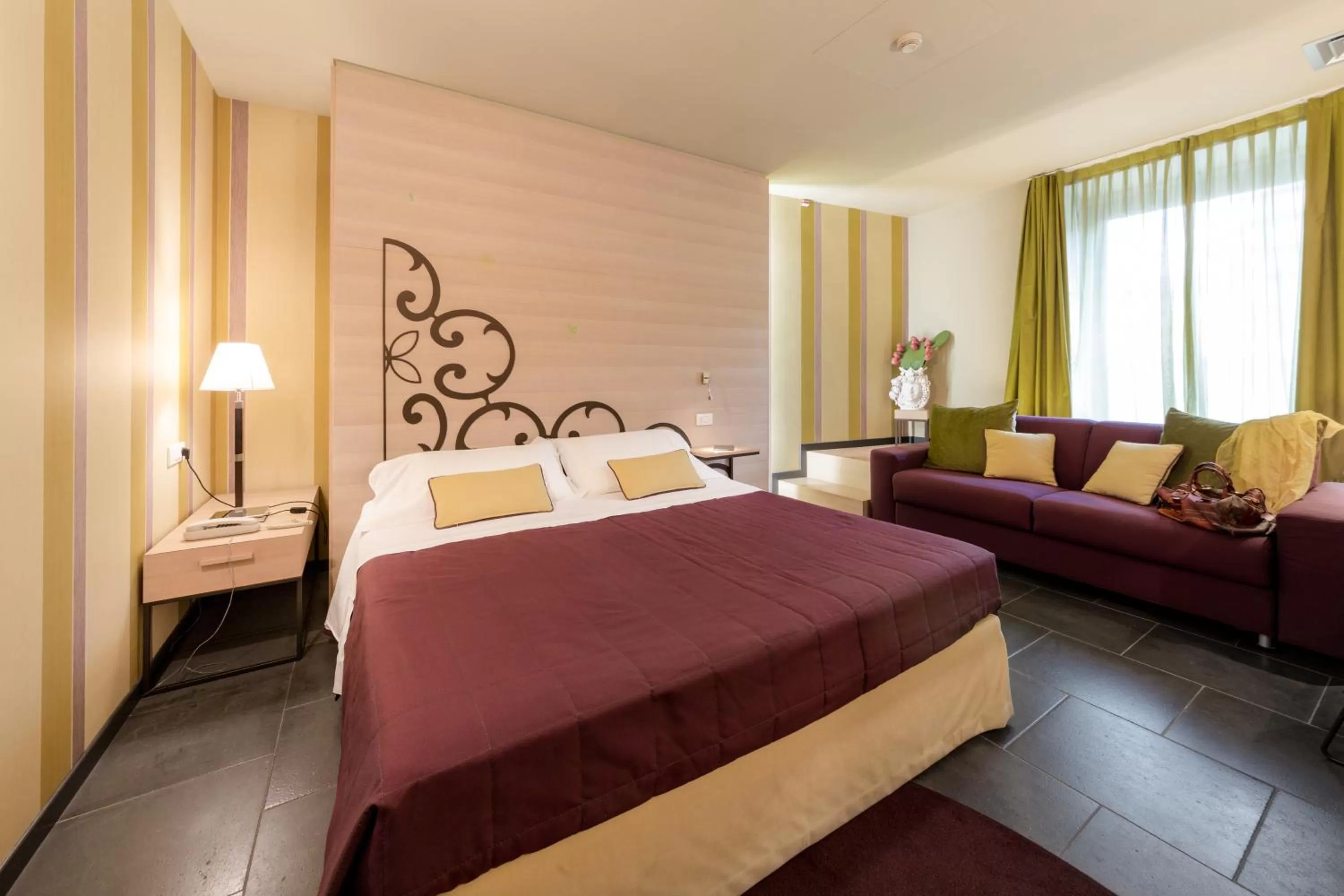 Living room, Bed in El Homs Palace Hotel