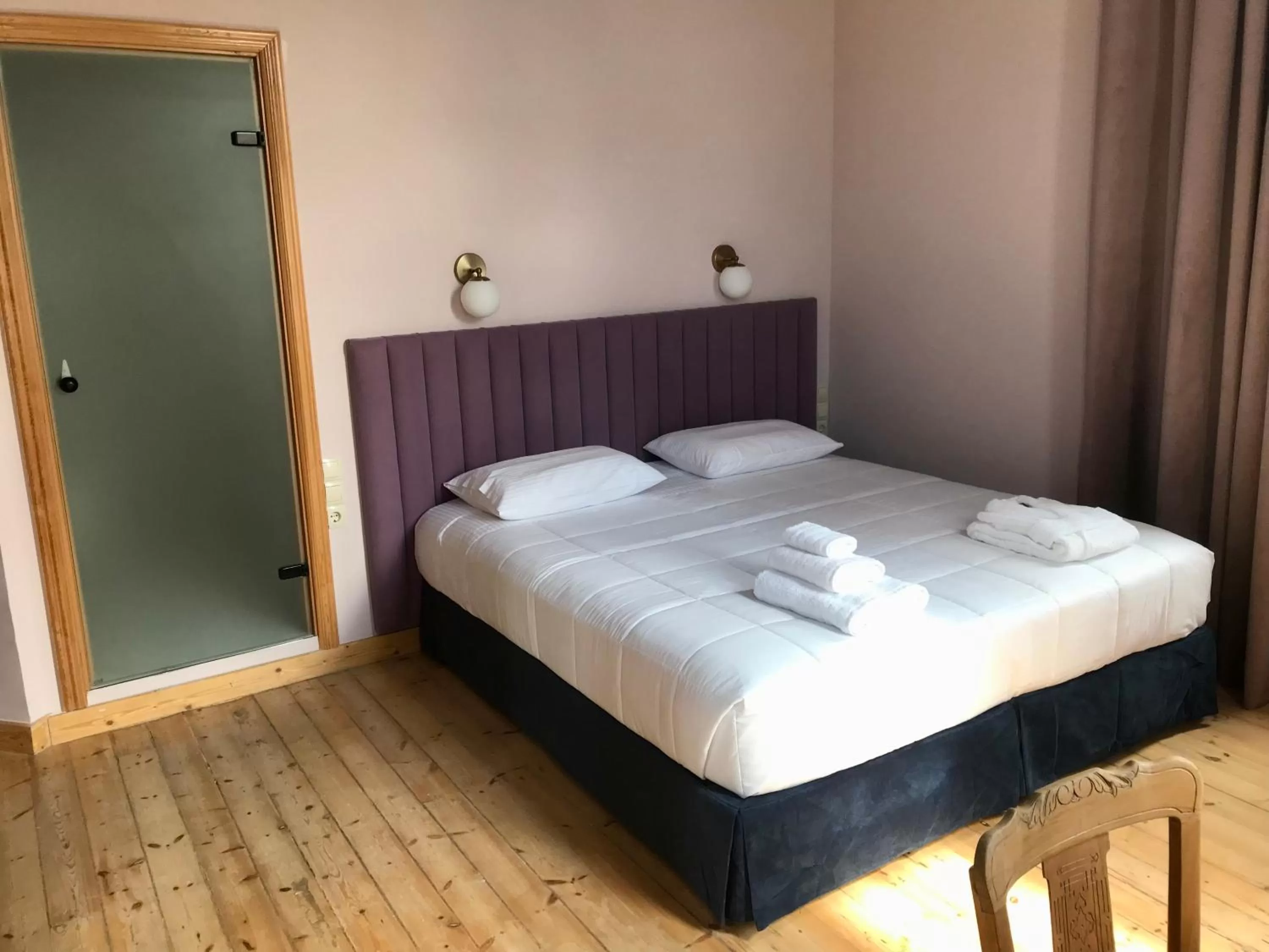 Photo of the whole room, Bed in VASILIKON Hotel 1888 the past is present HISTORICAL PRESERVATION MONUMENT