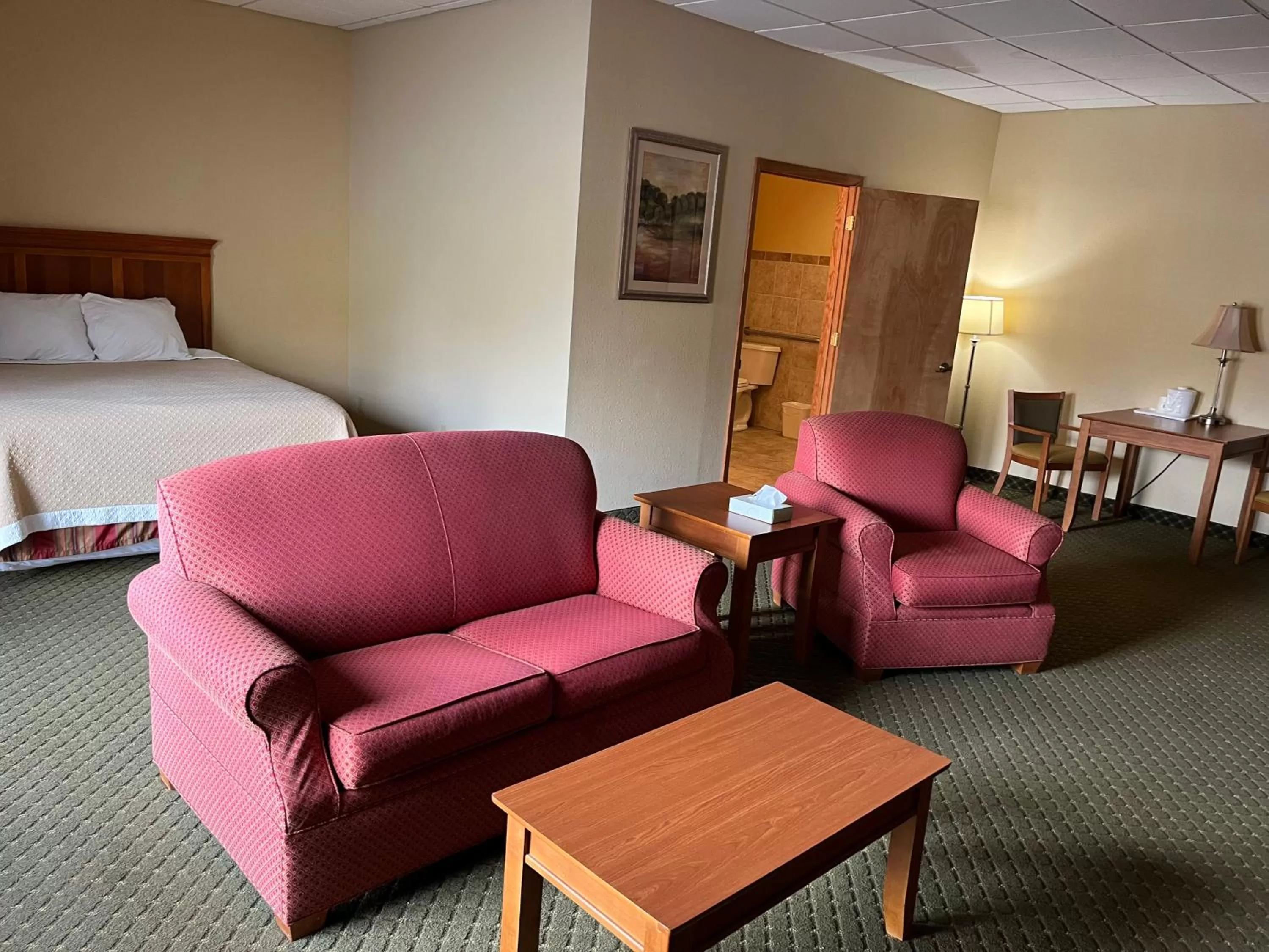 Seating area, Bed in Days Inn & Suites by Wyndham Sutton Flatwoods