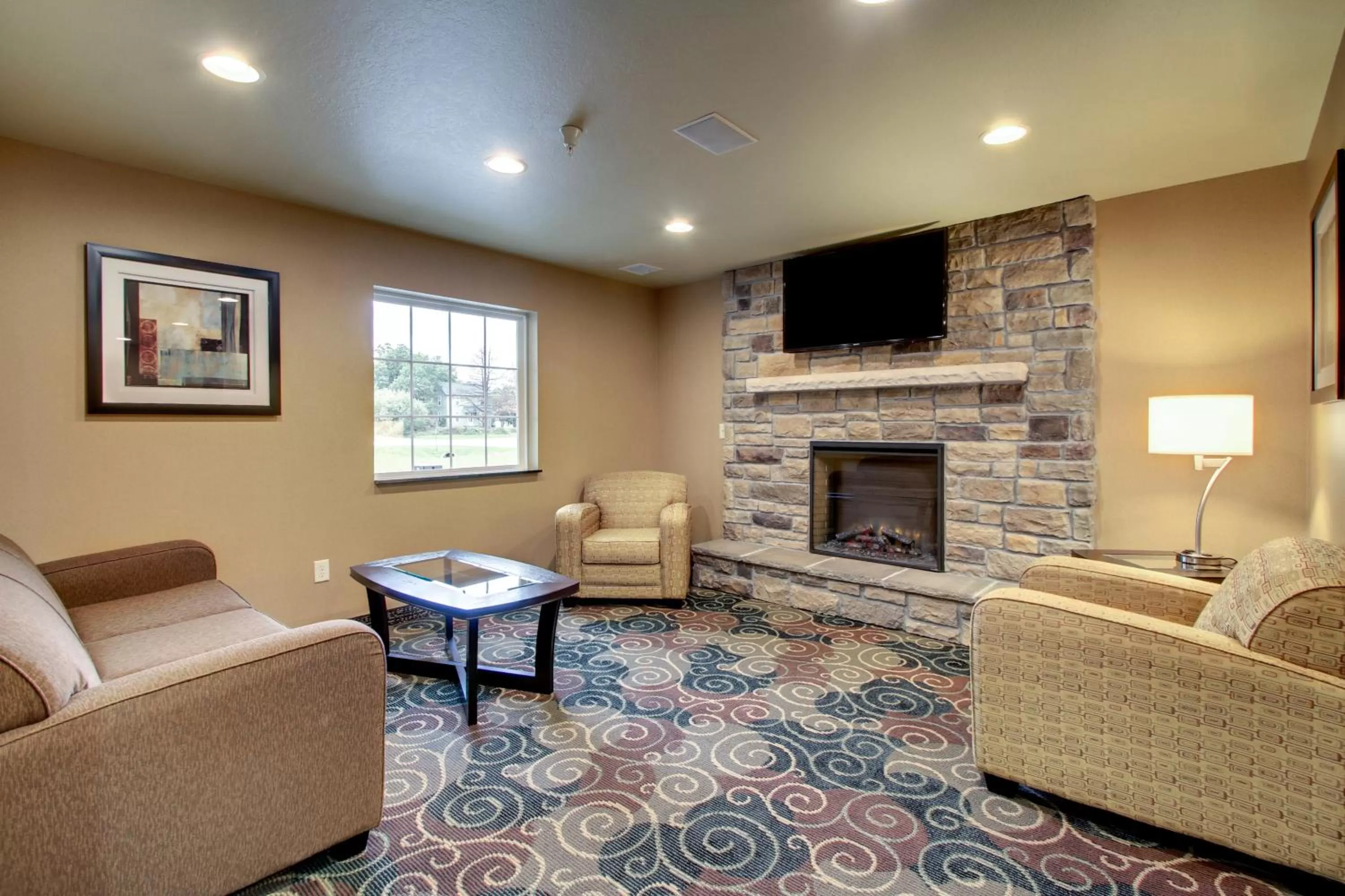 Communal lounge/ TV room in Cobblestone Inn & Suites - Schuyler