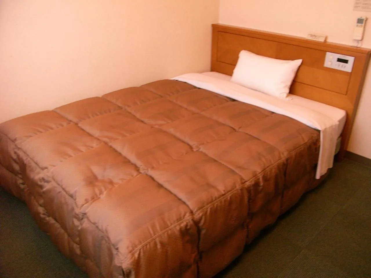 Bed in Hotel Route-Inn Aso Kumamoto Airport Ekimae