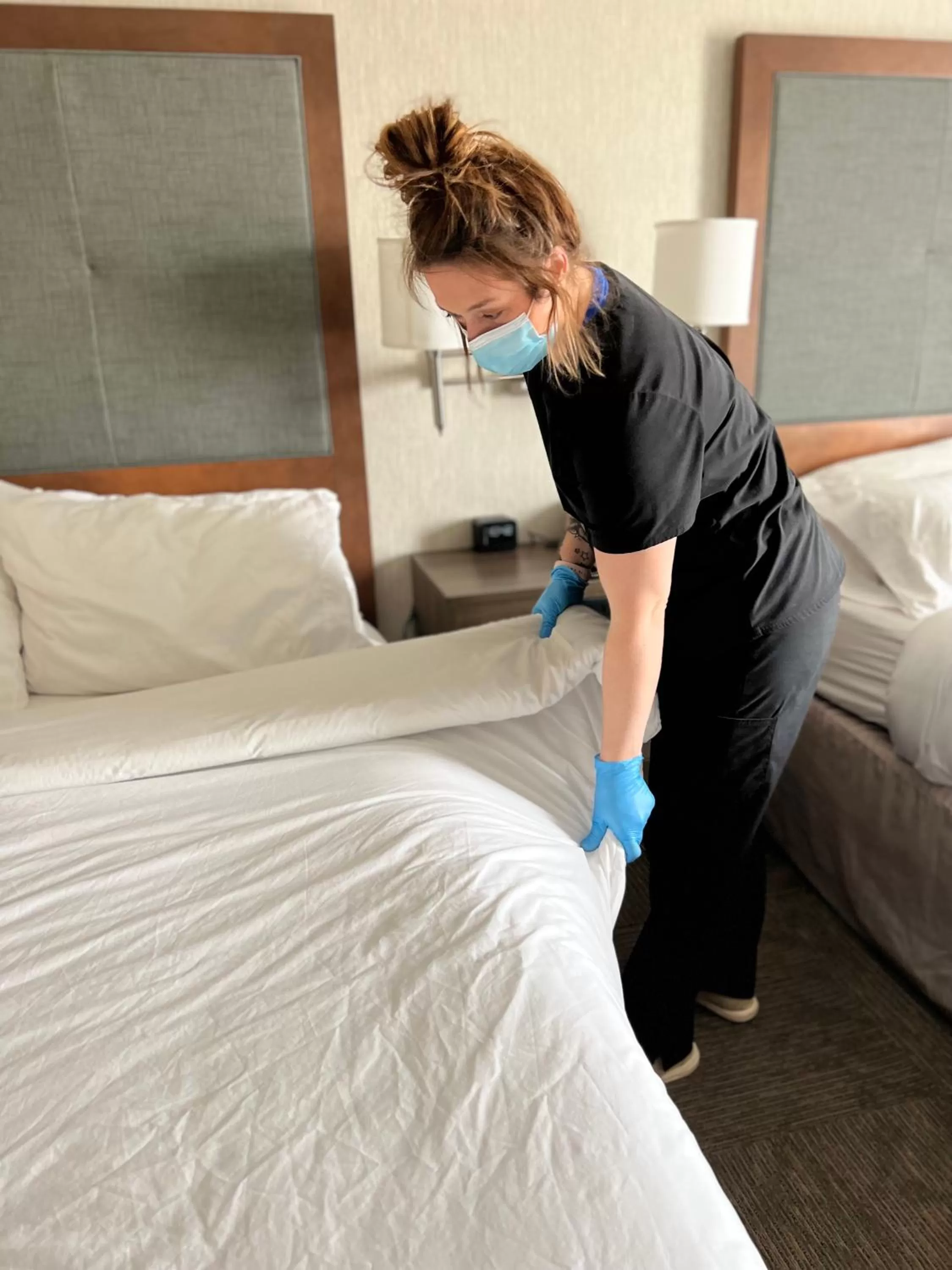 People, Bed in Flag Point Inn and Suites Pratt by FairBridge