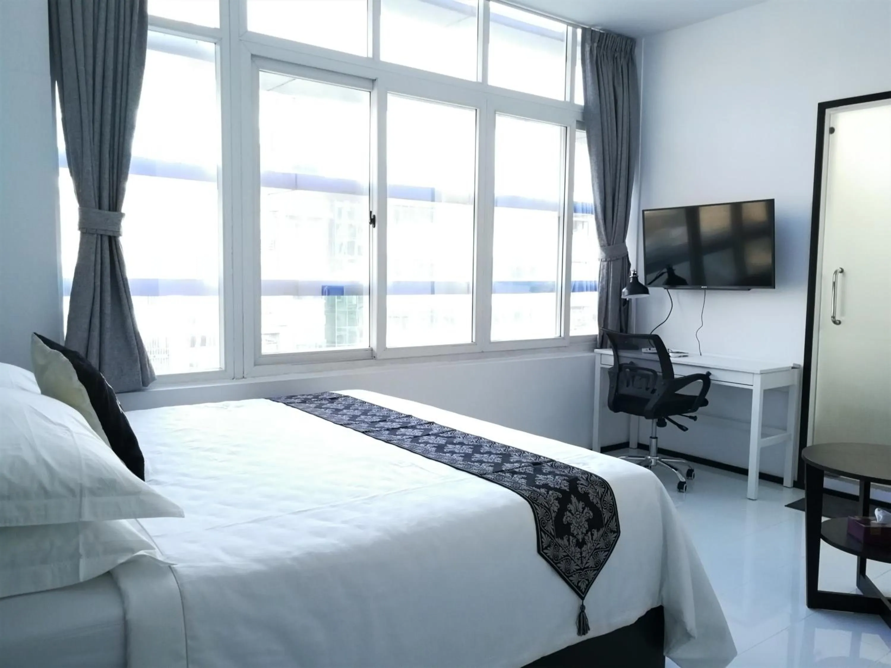 Bed in YAMA HOTEL & ROOFTOP BAR