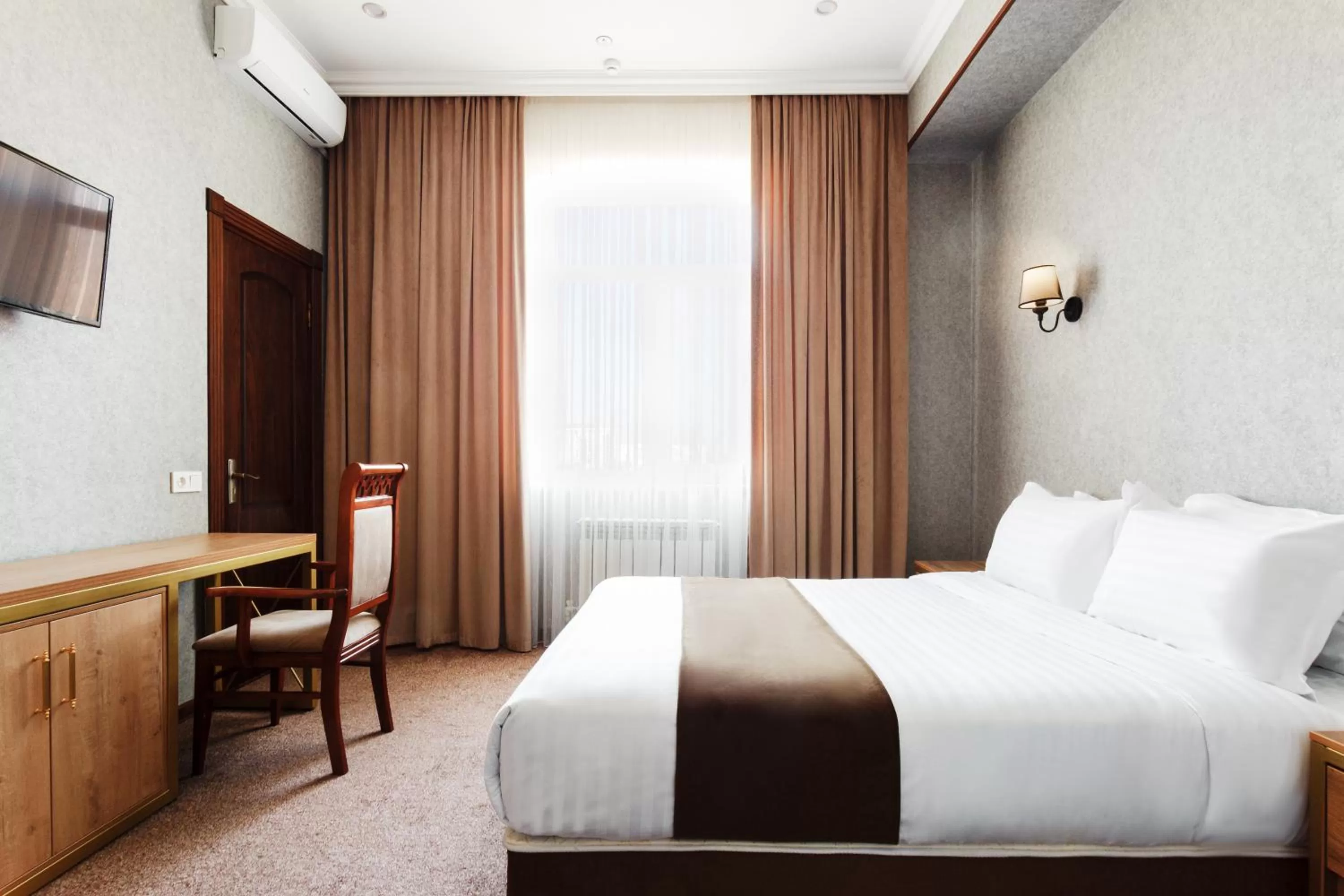 Bed in Western Suites Hotel