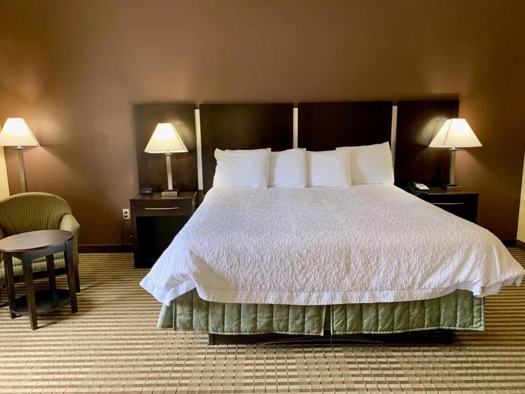 Bed in Whitney Inn & Suites