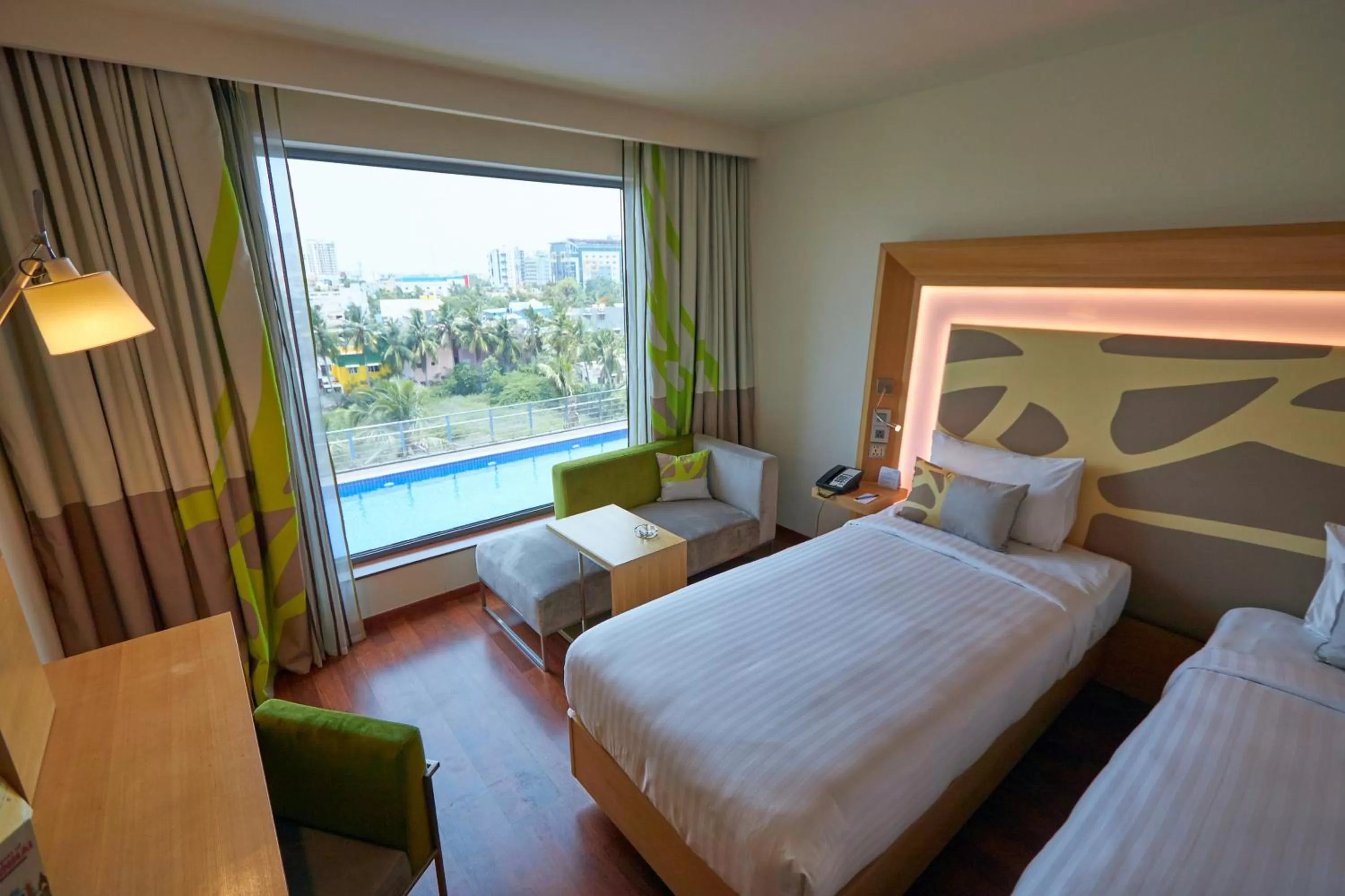 Pool view, Bed in Novotel Chennai OMR