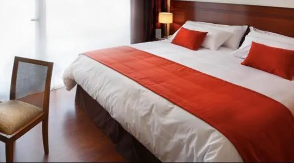 Bed in Herradura Hotel Suites