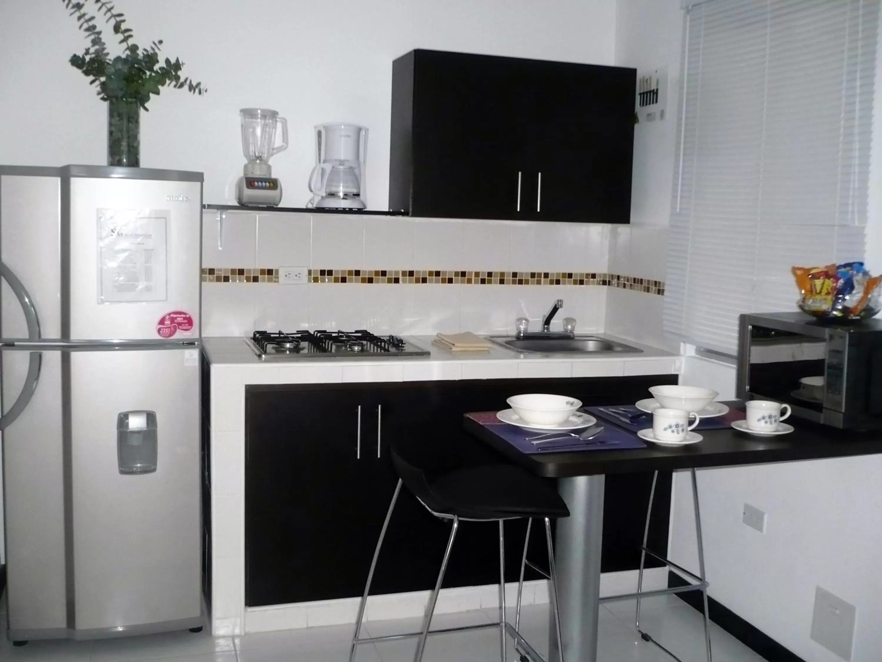Kitchen or kitchenette in Apartasuites San Marcos