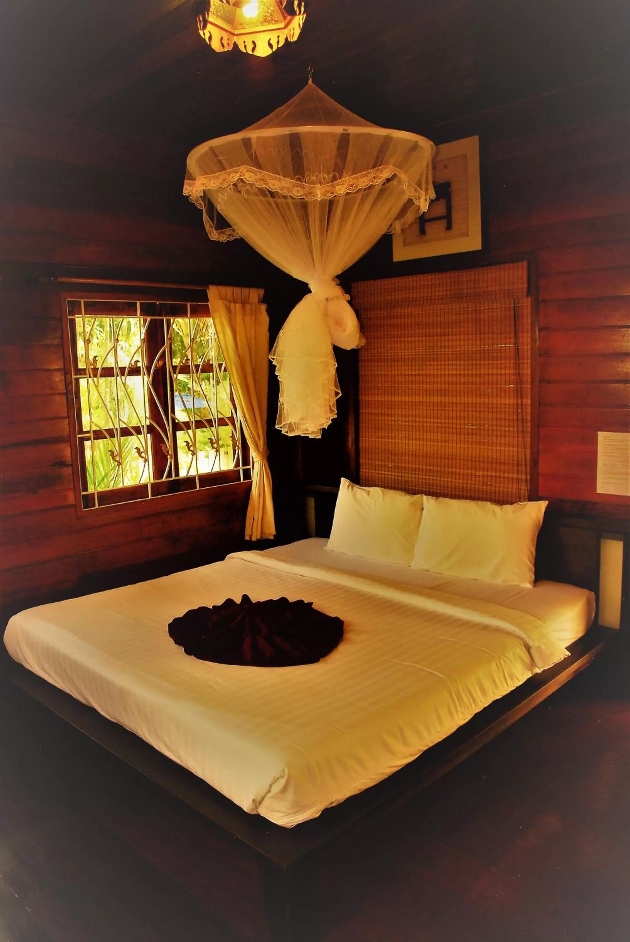 Bed in Cozy Garden Resort