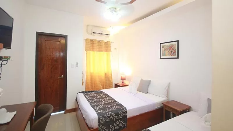 Bed in El Nido Royal Palm Inn