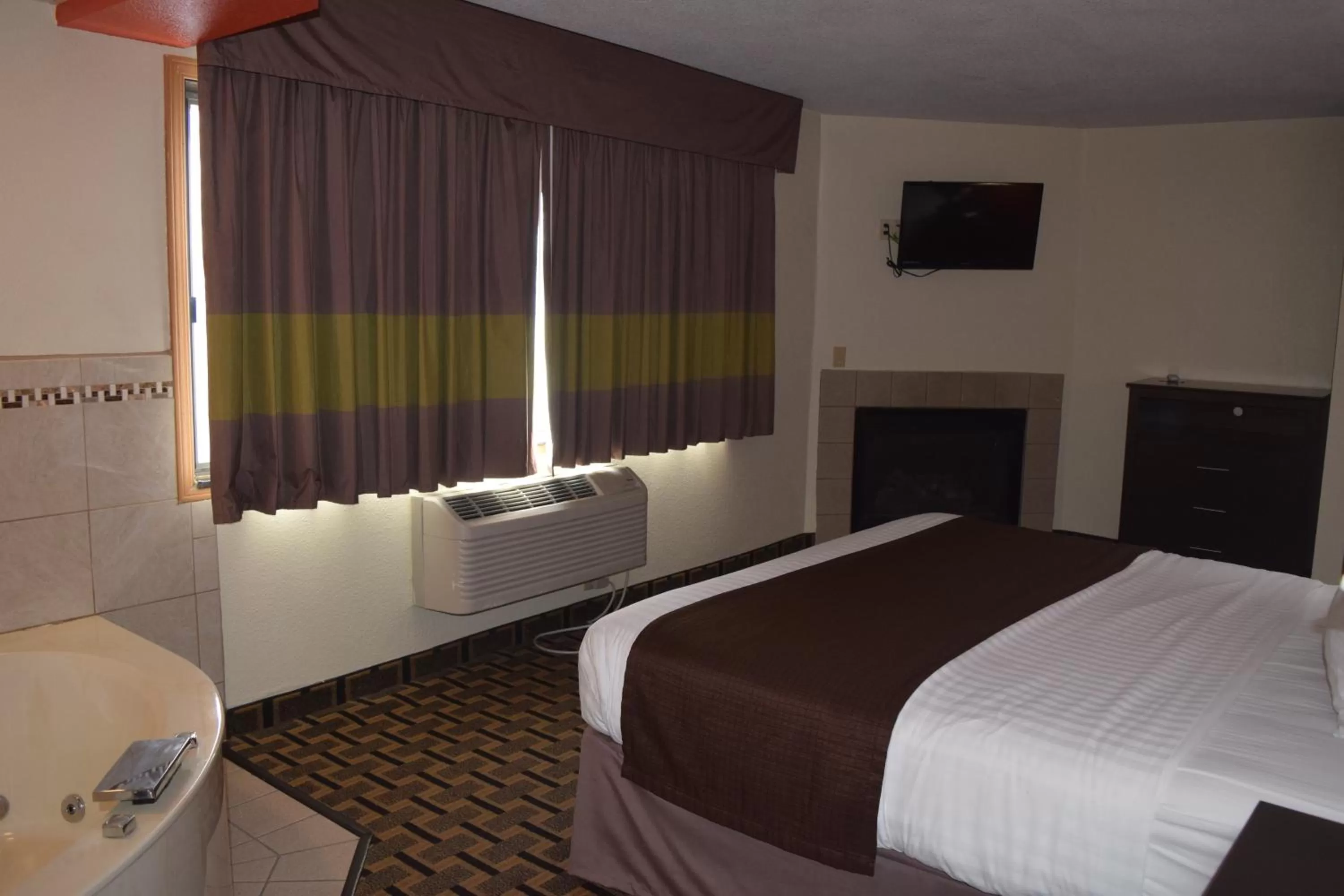 Bed in AmericInn by Wyndham West Burlington