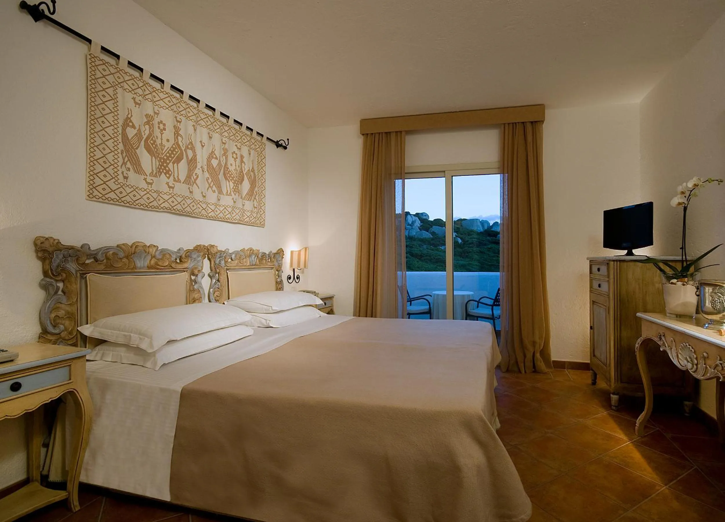 Photo of the whole room, Bed in COLONNA GRAND HOTEL CAPO TESTA, a Colonna Luxury Beach Hotel, Santa Teresa Sardegna