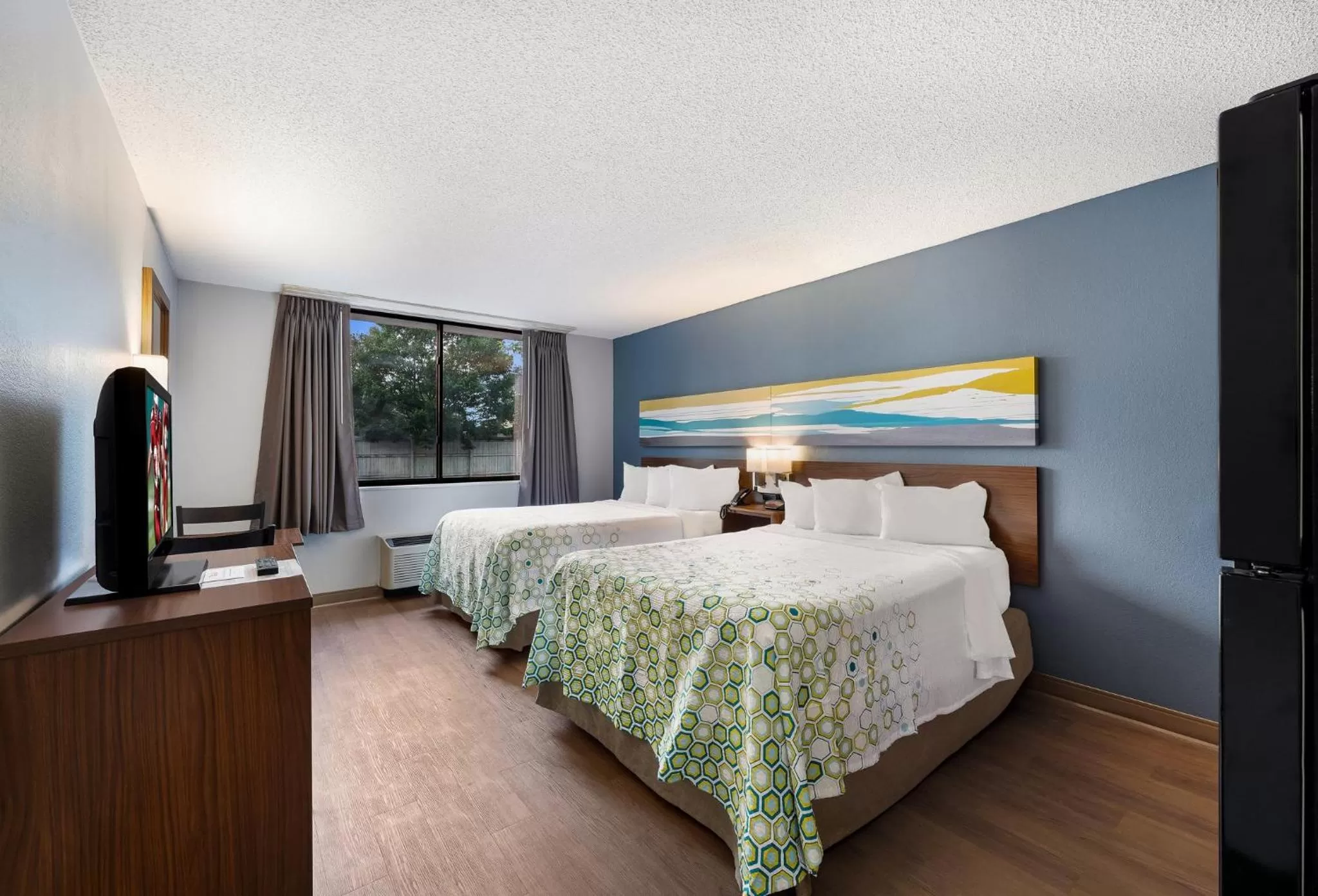 Photo of the whole room, Bed in HomeTowne Studios by Red Roof Painted Post