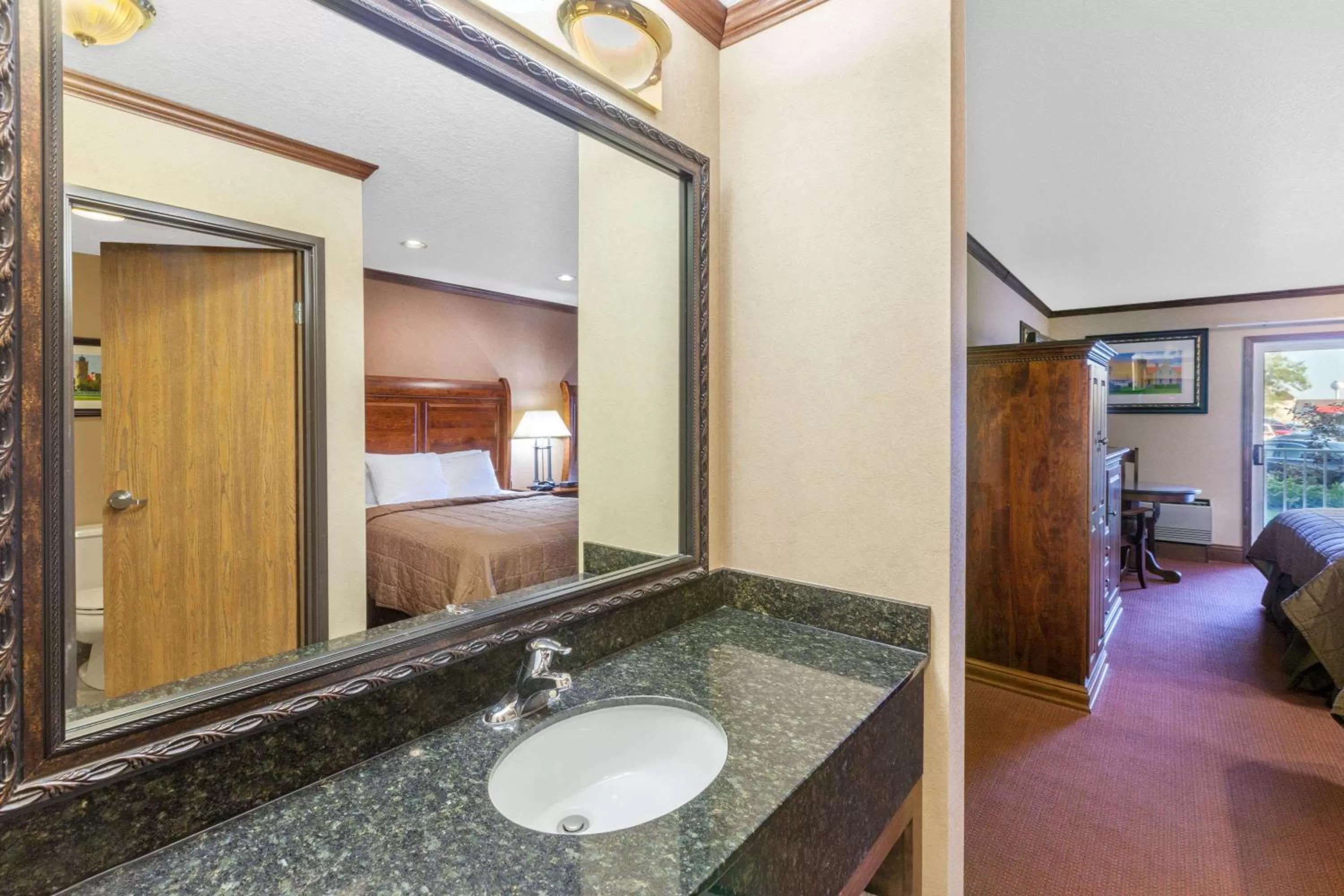 Bathroom, Bed in Ramada by Wyndham Mackinaw City Waterfront