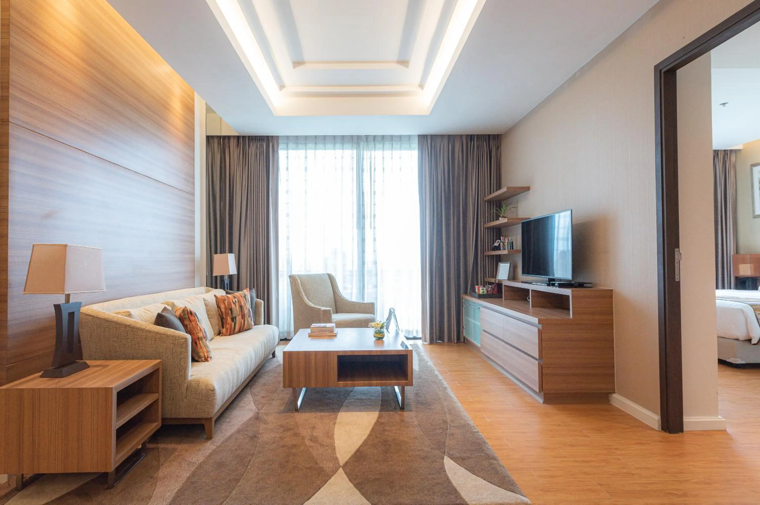 Living room, Bed in Summit Windmill Golf Suite Hotel at Suvarnabhumi